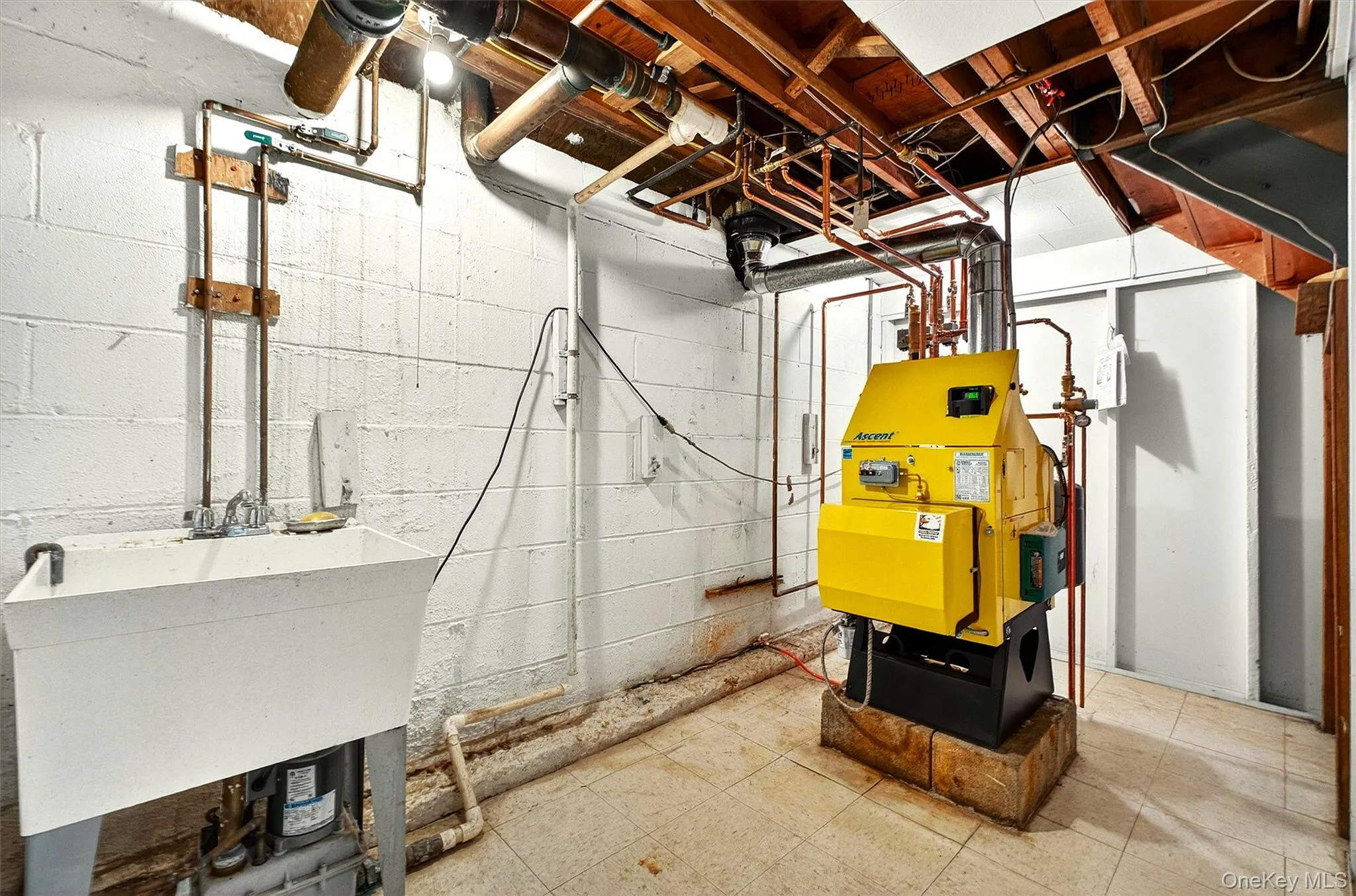Utility room featuring a laundry sink, boiler system, Utility room featuring a laundry sink, boiler system,