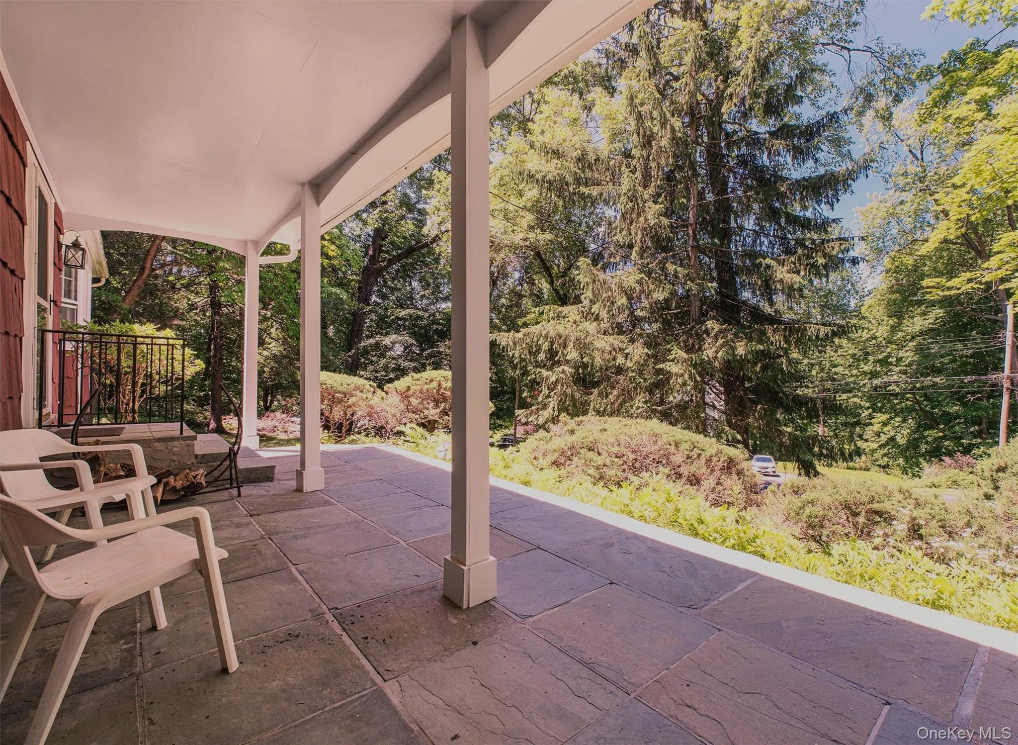 Covered front porch featuring large format stone tile flooring Covered front porch featuring large format stone tile flooring