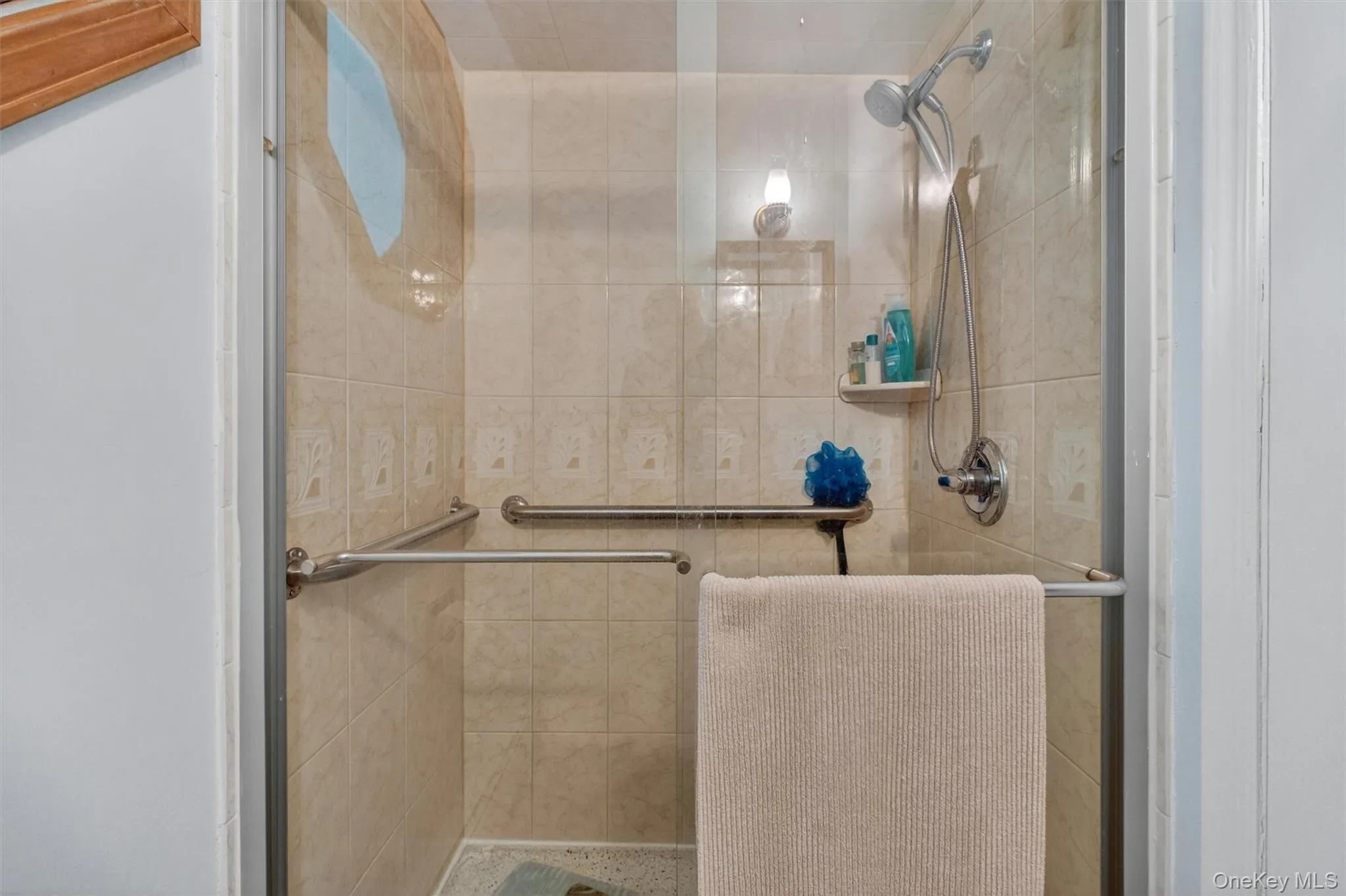 1st Fl. Full Bath w/Tiled shower enclosure featuring a clear glass door, chrome fixtures, and integrated grab bars 1st Fl. Full Bath w/Tiled shower enclosure featuring a clear glass door, chrome fixtures, and integrated grab bars