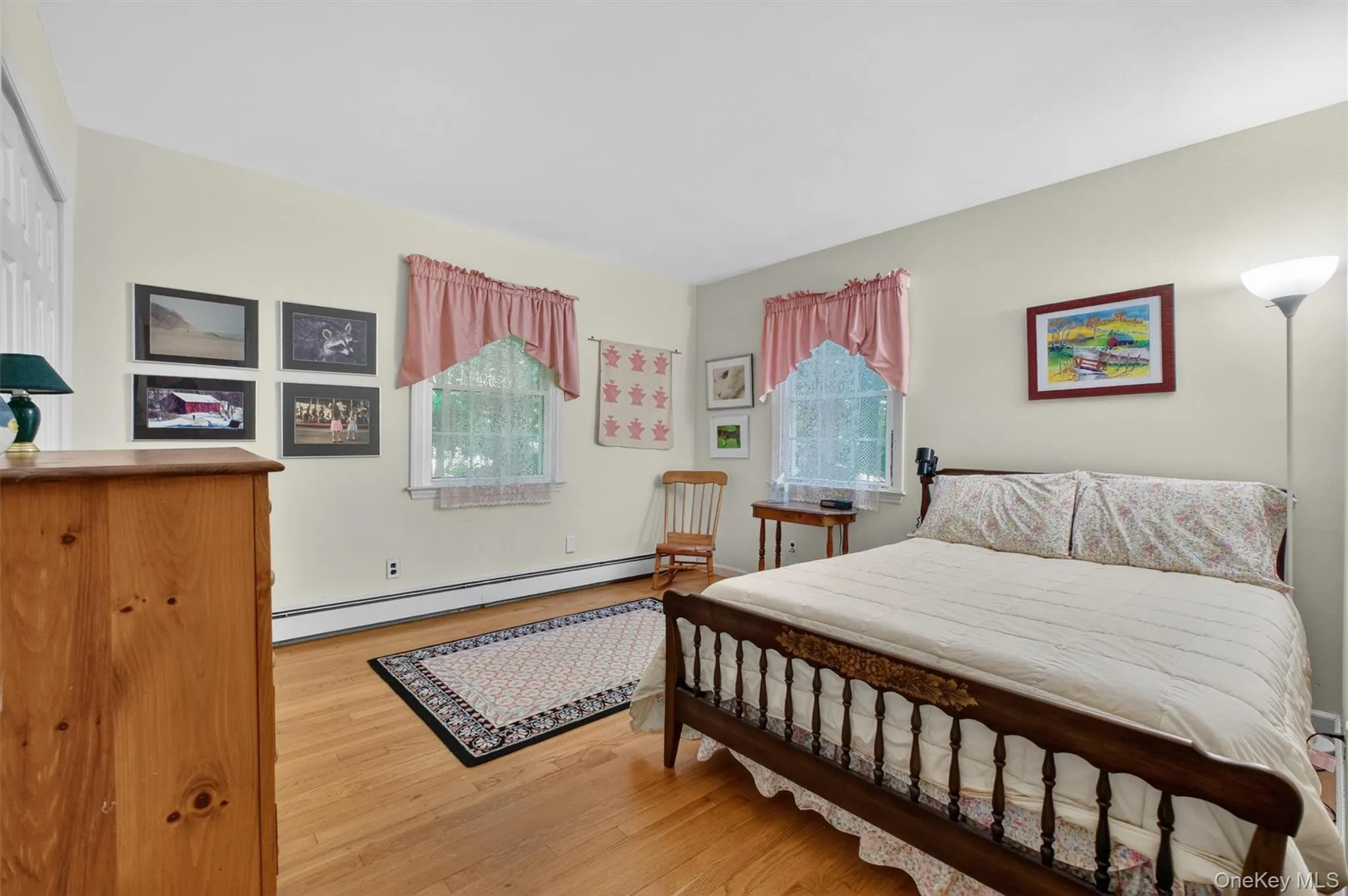 Bedroom #3 w/wood-finish flooring, two windows, and light-toned wall paint Bedroom #3 w/wood-finish flooring, two windows, and light-toned wall paint