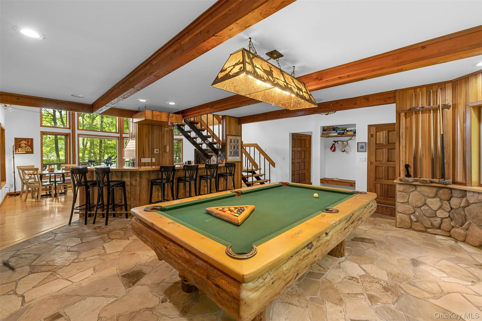 Playroom with beamed ceiling, pool table, light stone finish floors, and recessed lighting Playroom with beamed ceiling, pool table, light stone finish floors, and recessed lighting