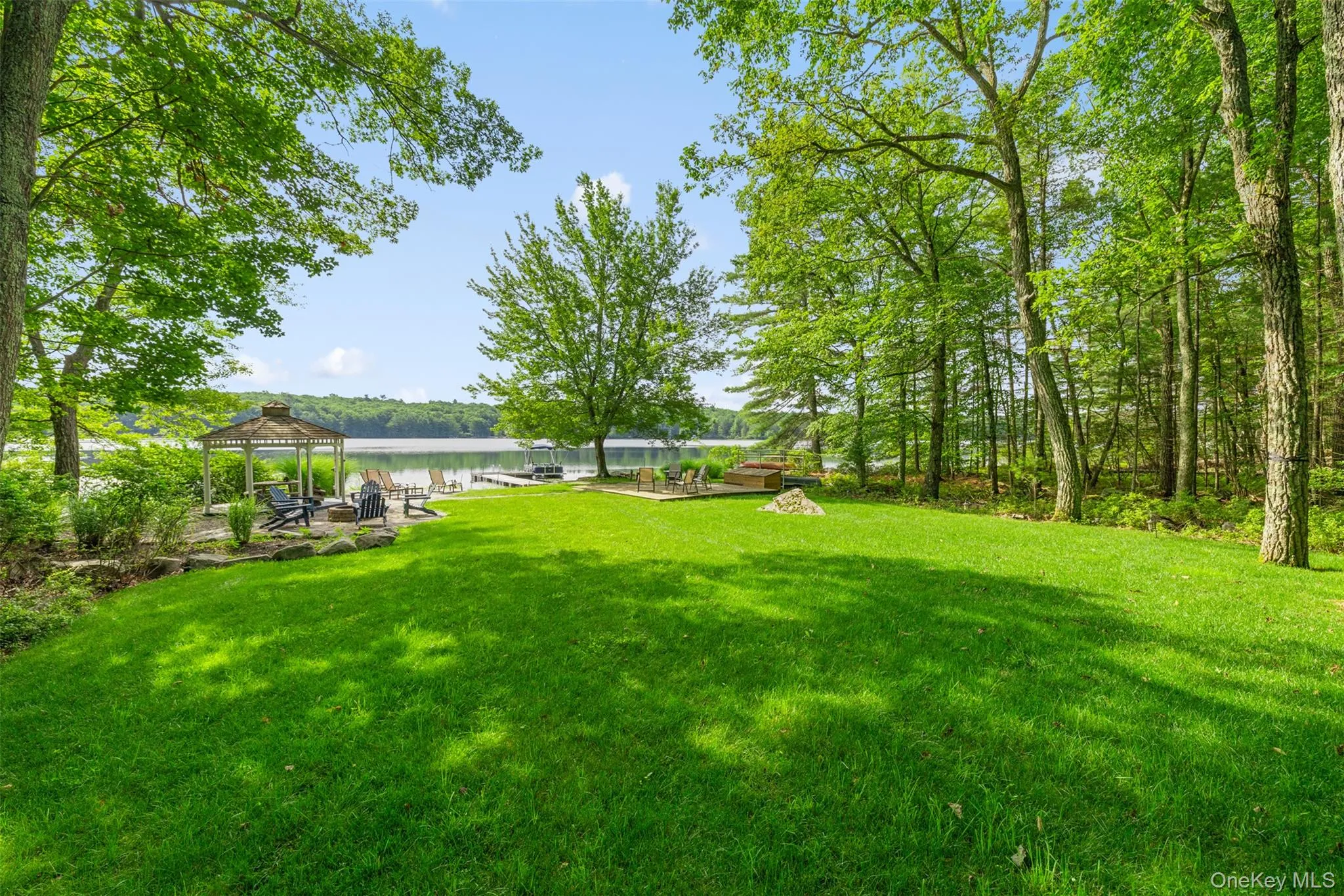 View of green lawn featuring a gazebo and a water view View of green lawn featuring a gazebo and a water view