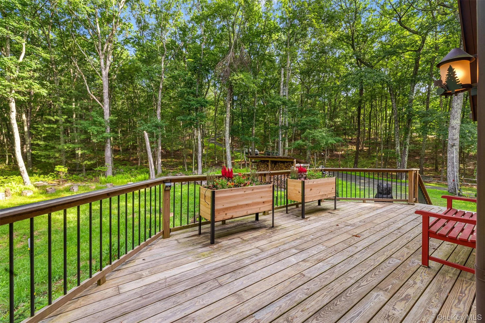 Wooden deck featuring a lawn Wooden deck featuring a lawn