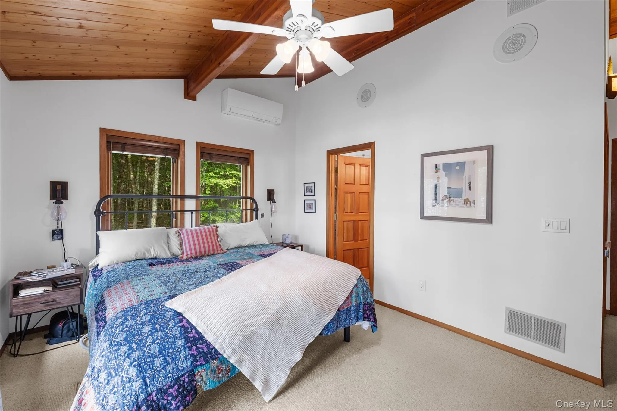 Bedroom with a wall mounted AC, wooden ceiling, carpet flooring, and a ceiling fan Bedroom with a wall mounted AC, wooden ceiling, carpet flooring, and a ceiling fan