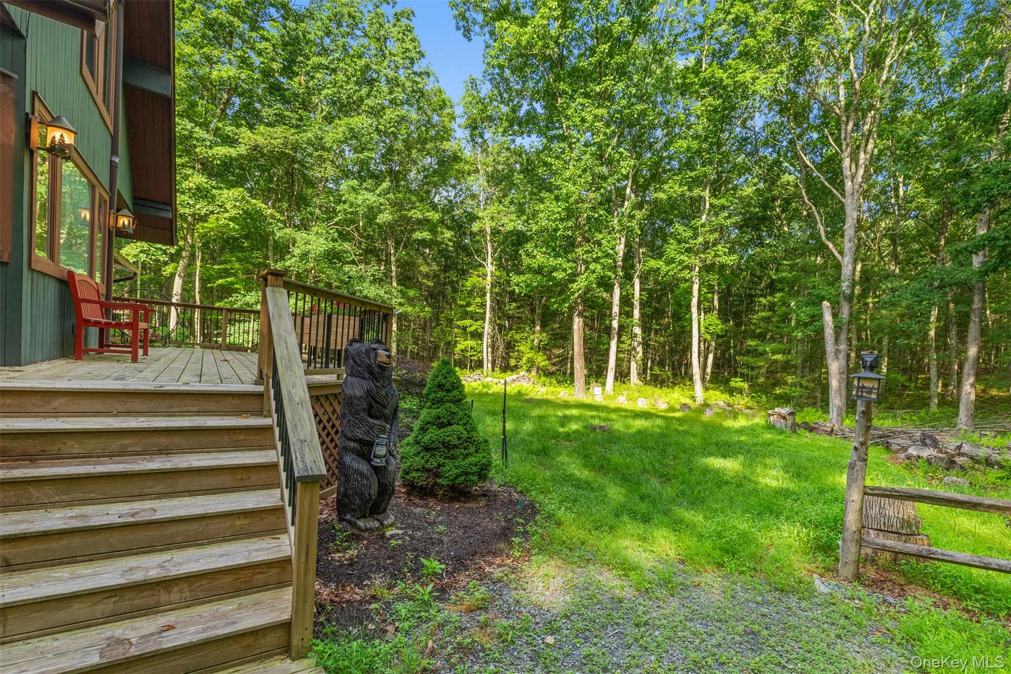 View of grassy yard featuring a deck View of grassy yard featuring a deck