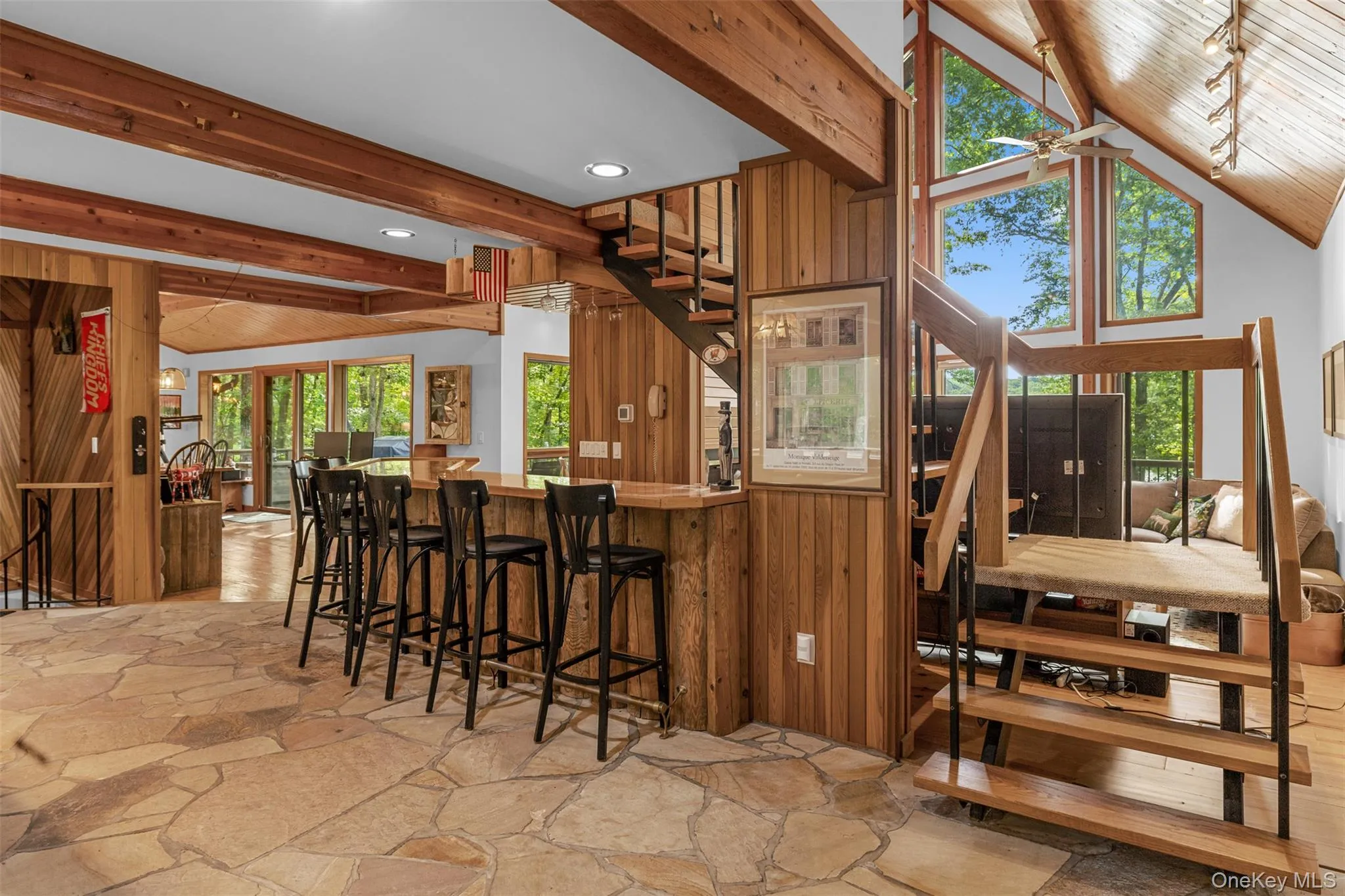 Kitchen featuring stone flooring, beamed ceiling, recessed lighting, and a breakfast bar area Kitchen featuring stone flooring, beamed ceiling, recessed lighting, and a breakfast bar area