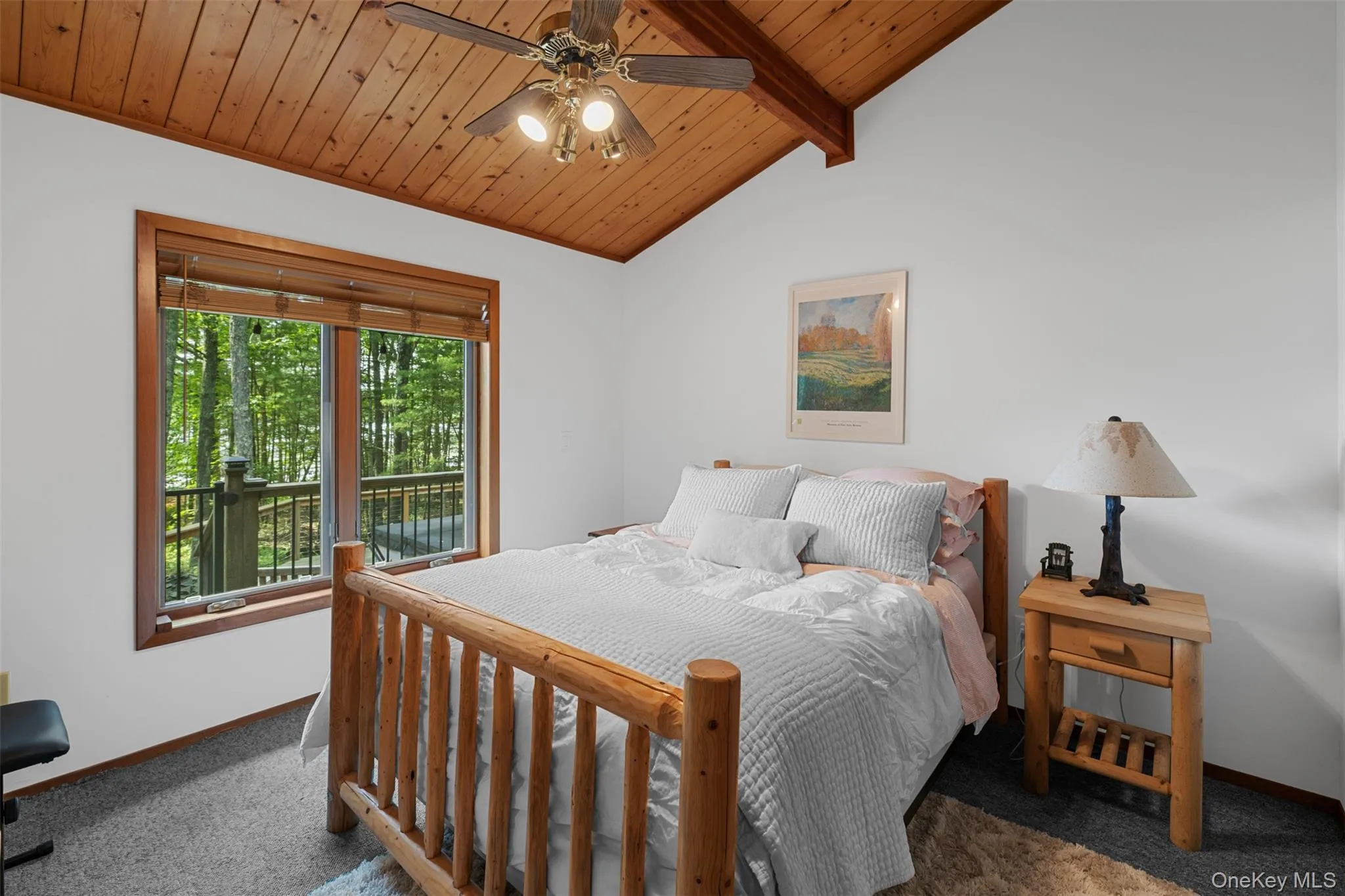 Bedroom with wood ceiling, carpet floors, and ceiling fan Bedroom with wood ceiling, carpet floors, and ceiling fan