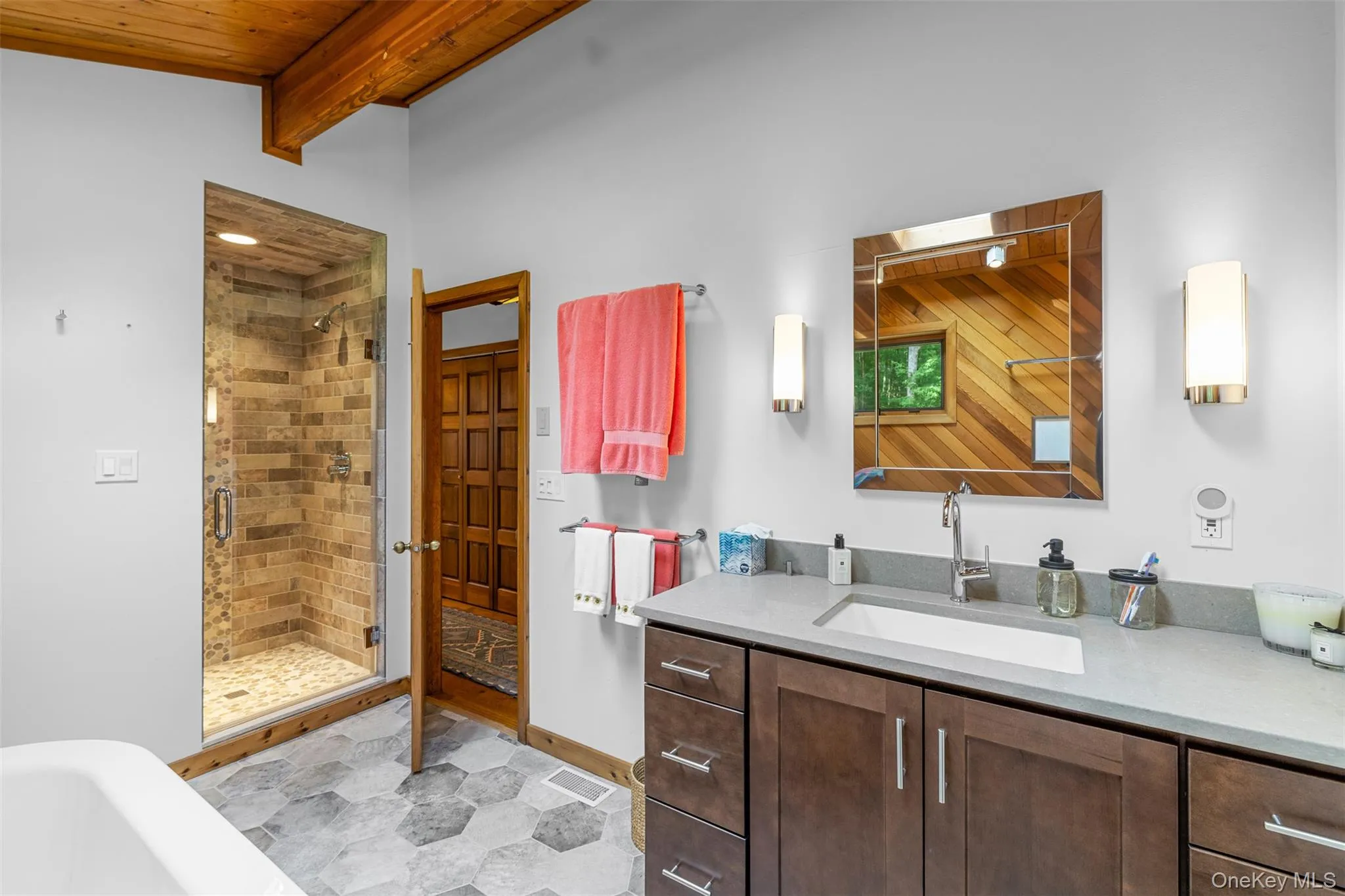Bathroom featuring a shower stall, vanity, a soaking tub, and a wood ceiling with exposed beams Bathroom featuring a shower stall, vanity, a soaking tub, and a wood ceiling with exposed beams