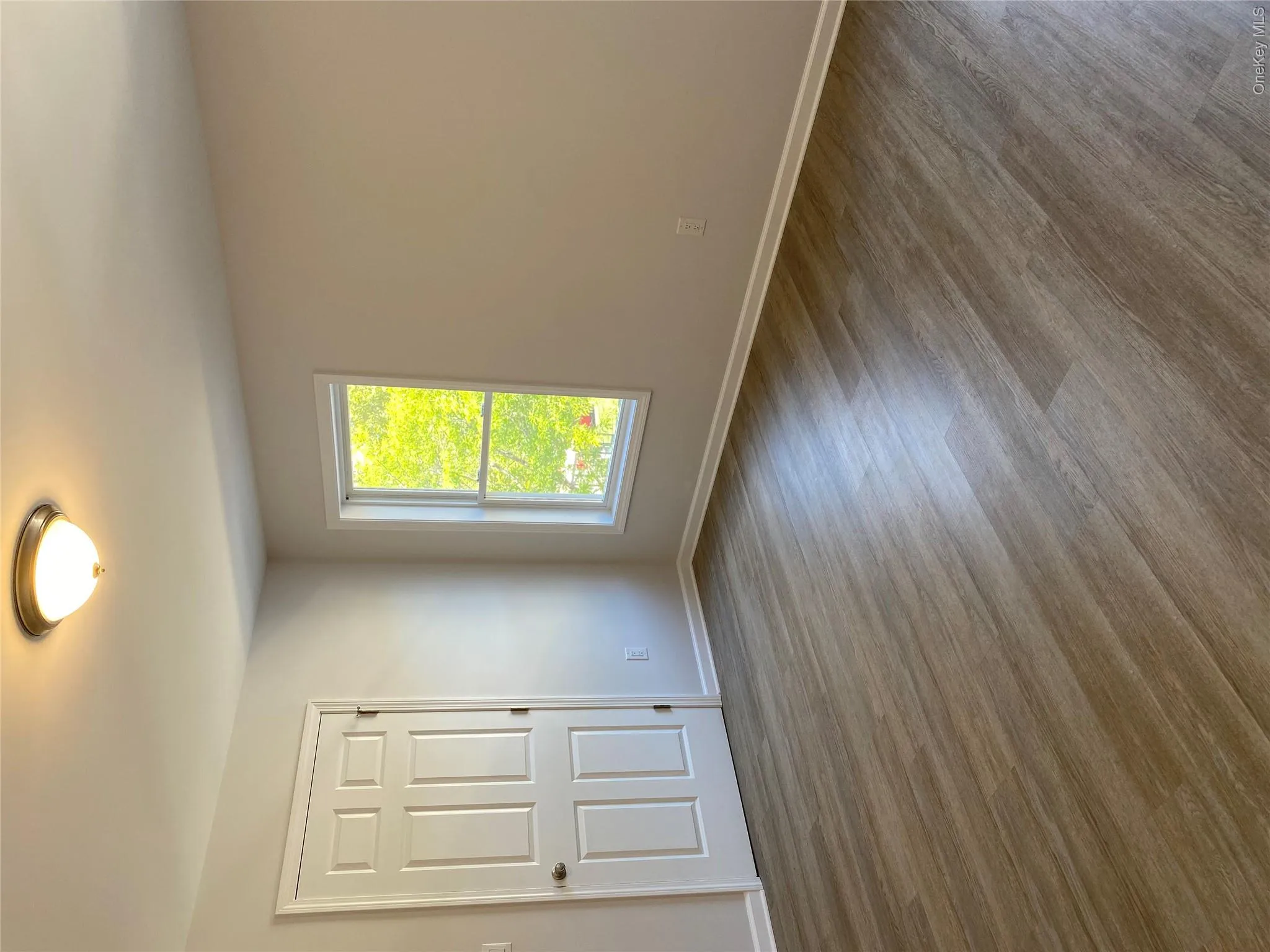 Unfurnished room with wood finished floors and baseboards Unfurnished room with wood finished floors and baseboards