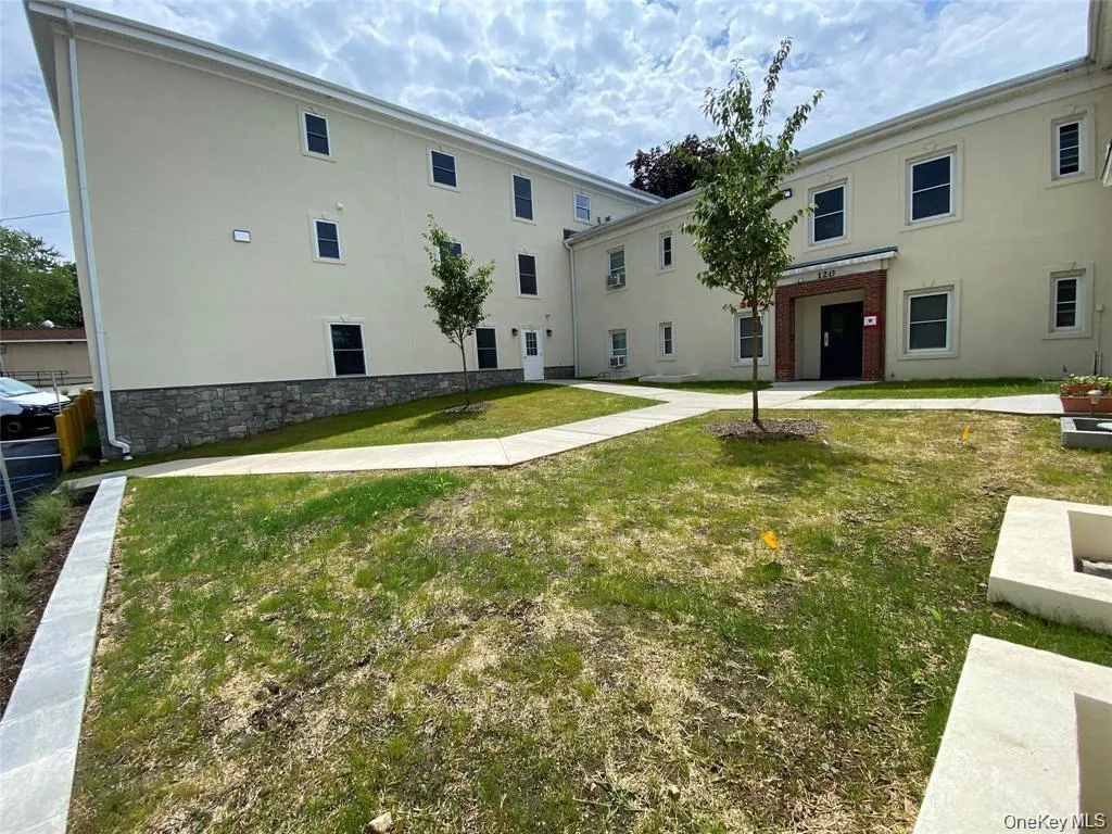 View of property's community with a lawn View of property's community with a lawn