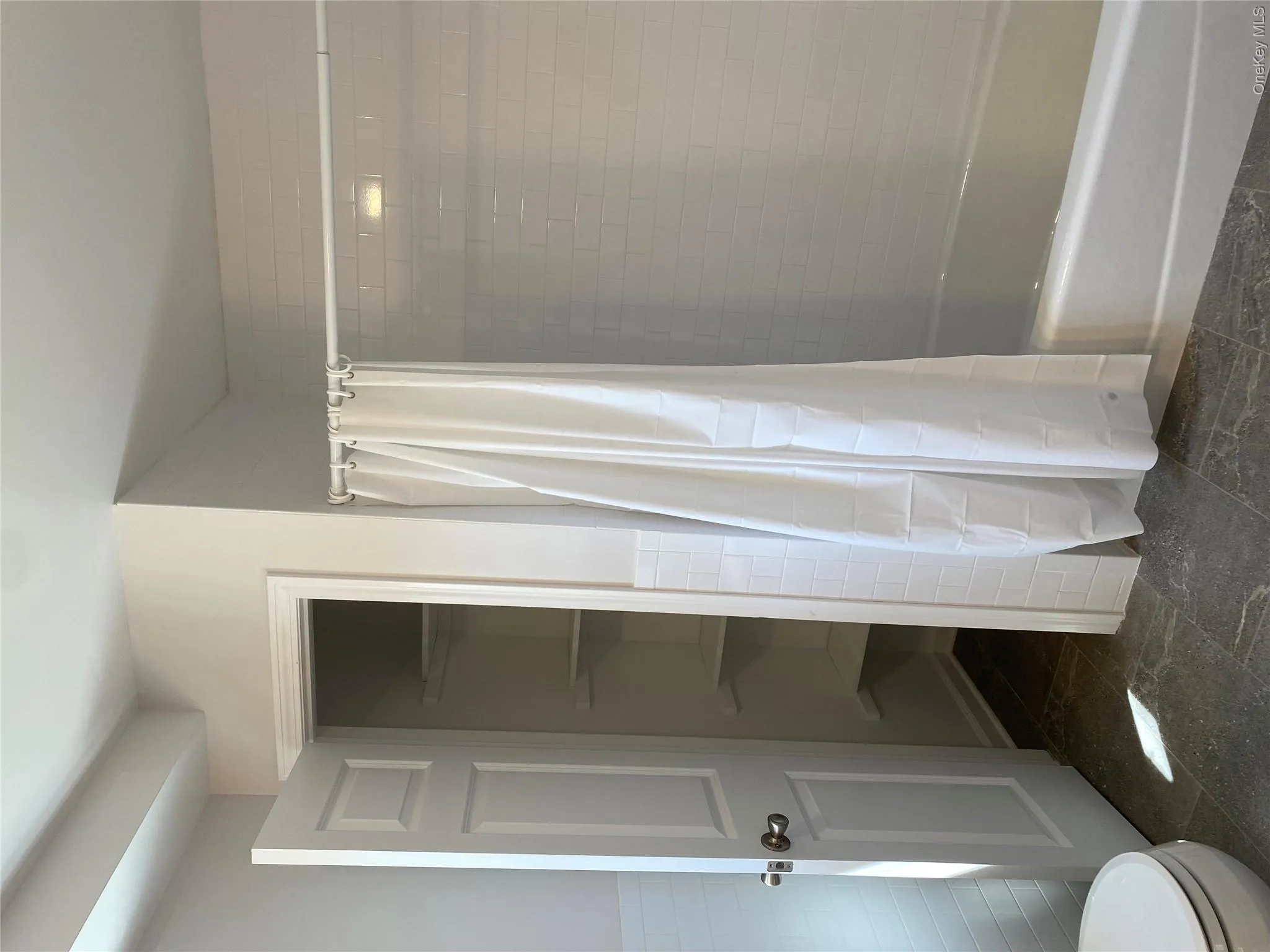 Bathroom with shower / tub combo with curtain and tile walls Bathroom with shower / tub combo with curtain and tile walls