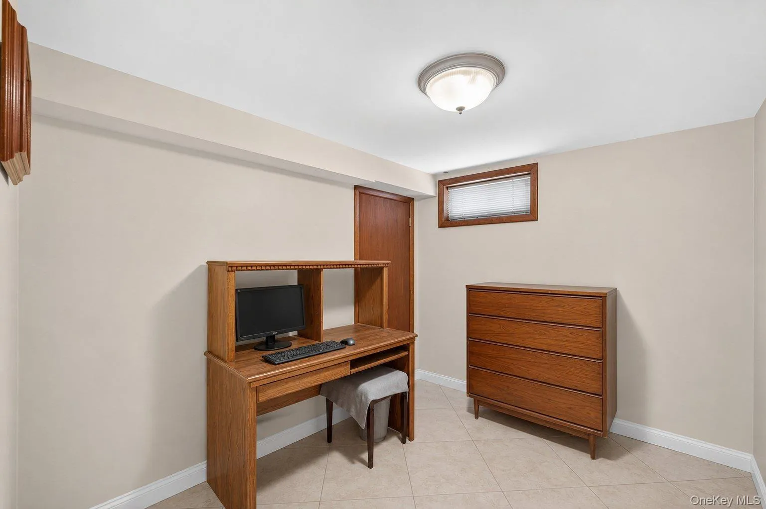 Cream-colored walls complimenting a tiled floor, featuring a built-in window and a flush-mount ceiling light Cream-colored walls complimenting a tiled floor, featuring a built-in window and a flush-mount ceiling light