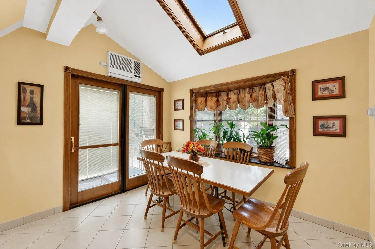 Vaulted ceiling with skylight and wood-framed window Vaulted ceiling with skylight and wood-framed window