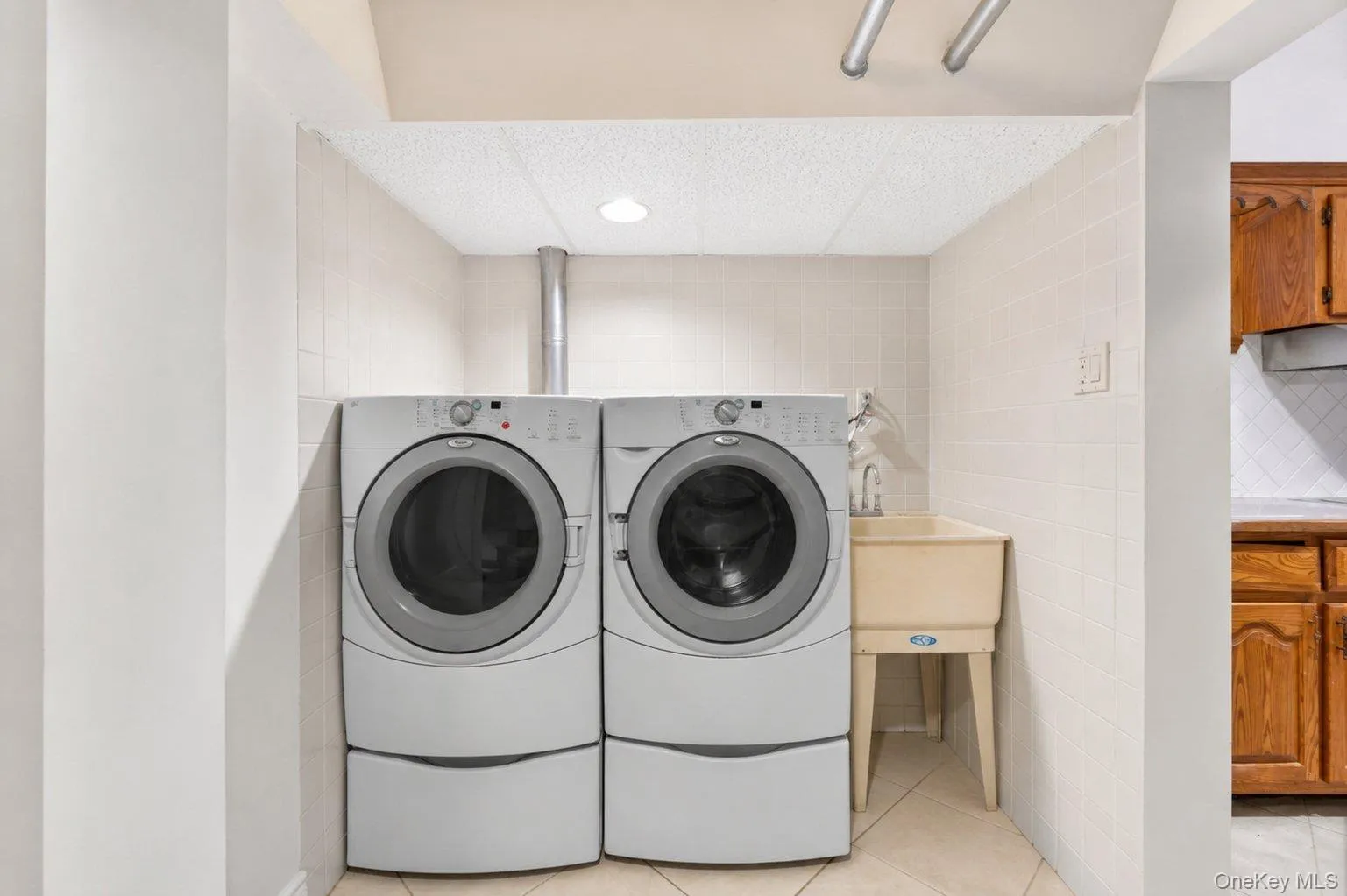 Dedicated laundry area featuring a side-by-side washer and dryer set Dedicated laundry area featuring a side-by-side washer and dryer set