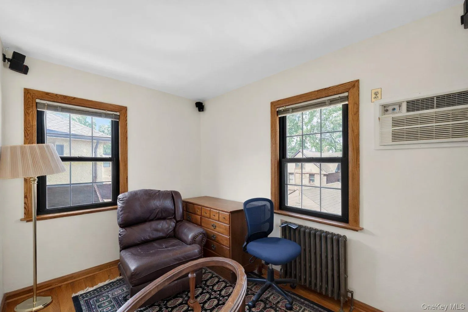 Hardwood flooring complemented by light-toned wall finishes and ceiling Hardwood flooring complemented by light-toned wall finishes and ceiling