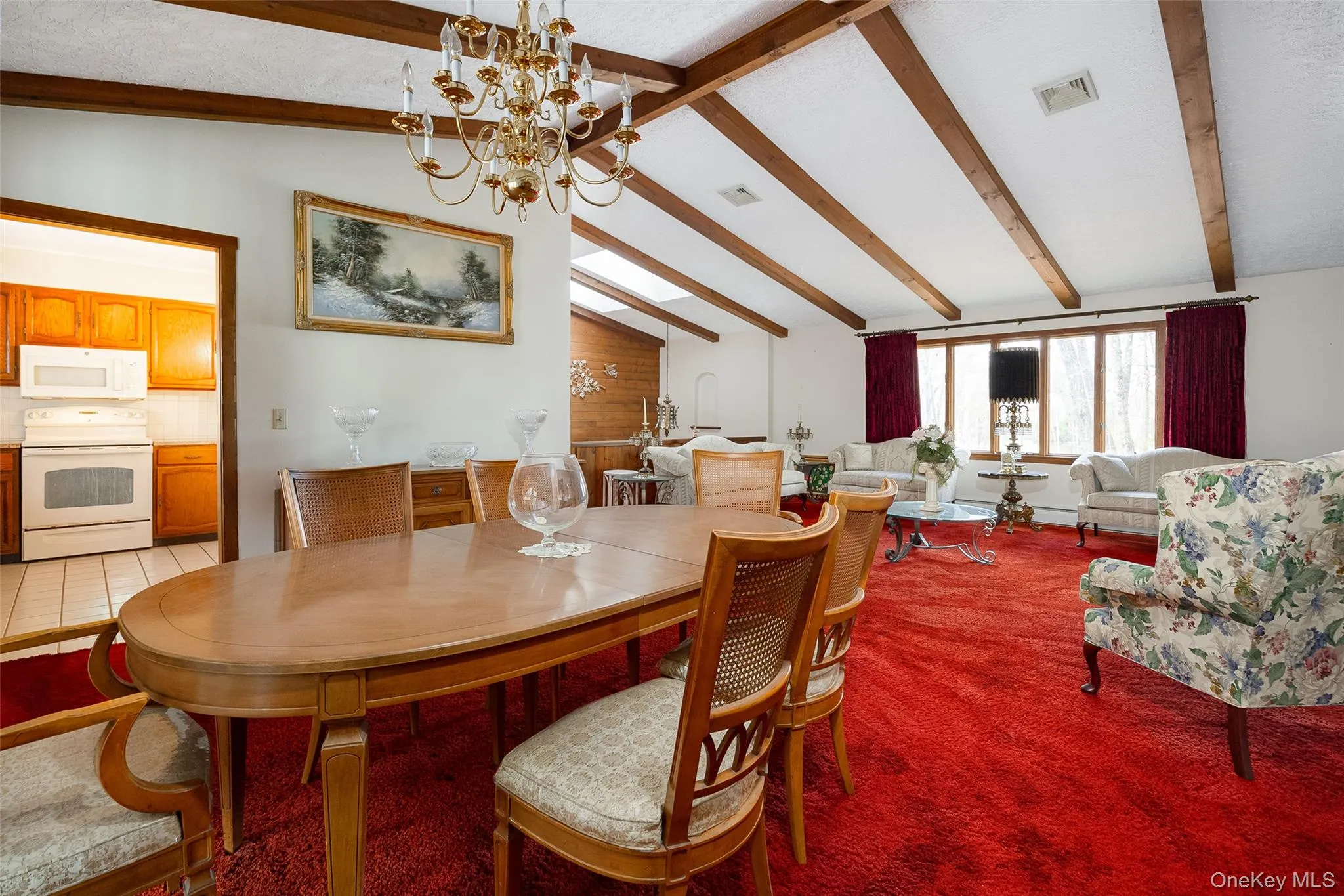 Dining space featuring a chandelier and light carpet Dining space featuring a chandelier and light carpet