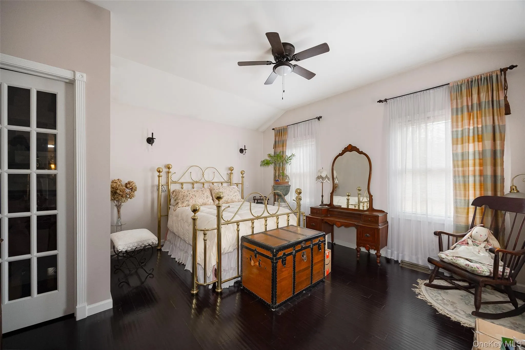 Bedroom with lofted ceiling, dark wood finished floors, and ceiling fan Bedroom with lofted ceiling, dark wood finished floors, and ceiling fan