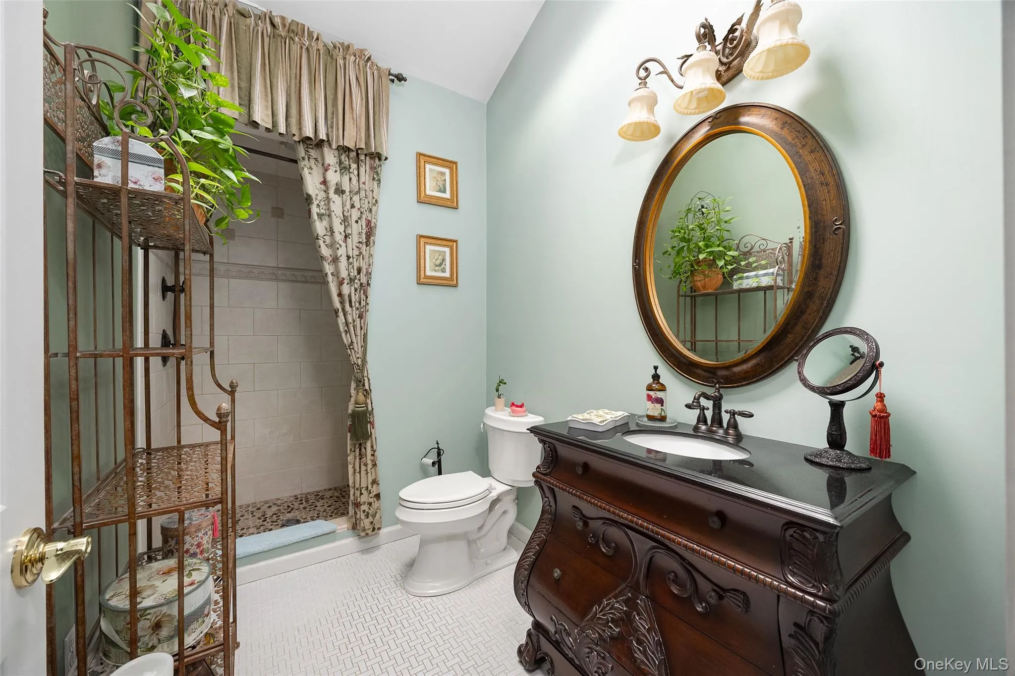 Full bathroom featuring vanity, tile patterned flooring, and tiled shower Full bathroom featuring vanity, tile patterned flooring, and tiled shower