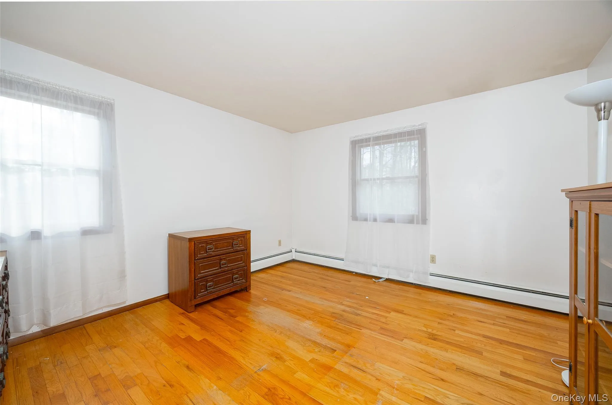 Unfurnished room featuring light wood finished floors Unfurnished room featuring light wood finished floors