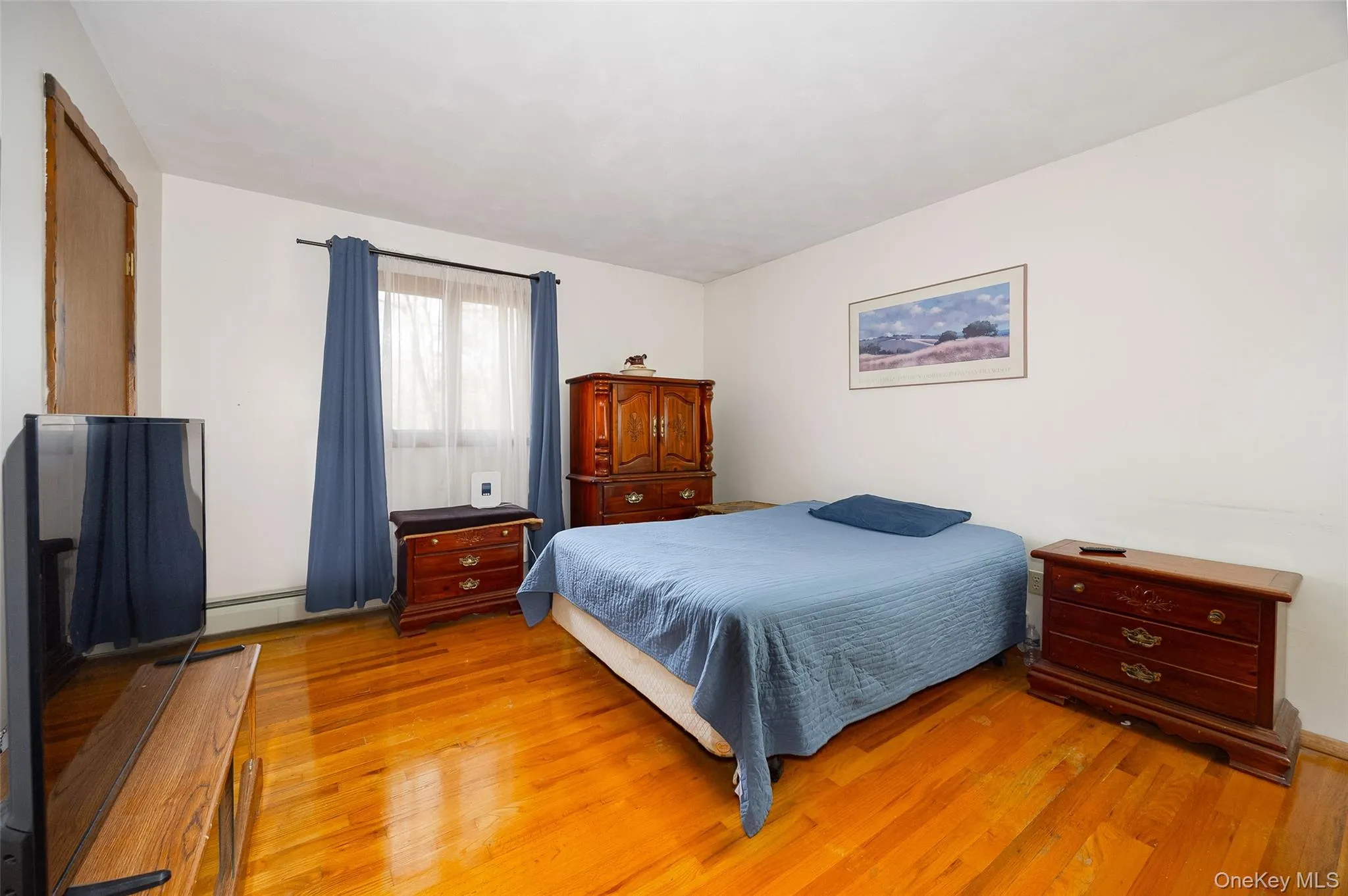 Bedroom with light wood finished floors Bedroom with light wood finished floors