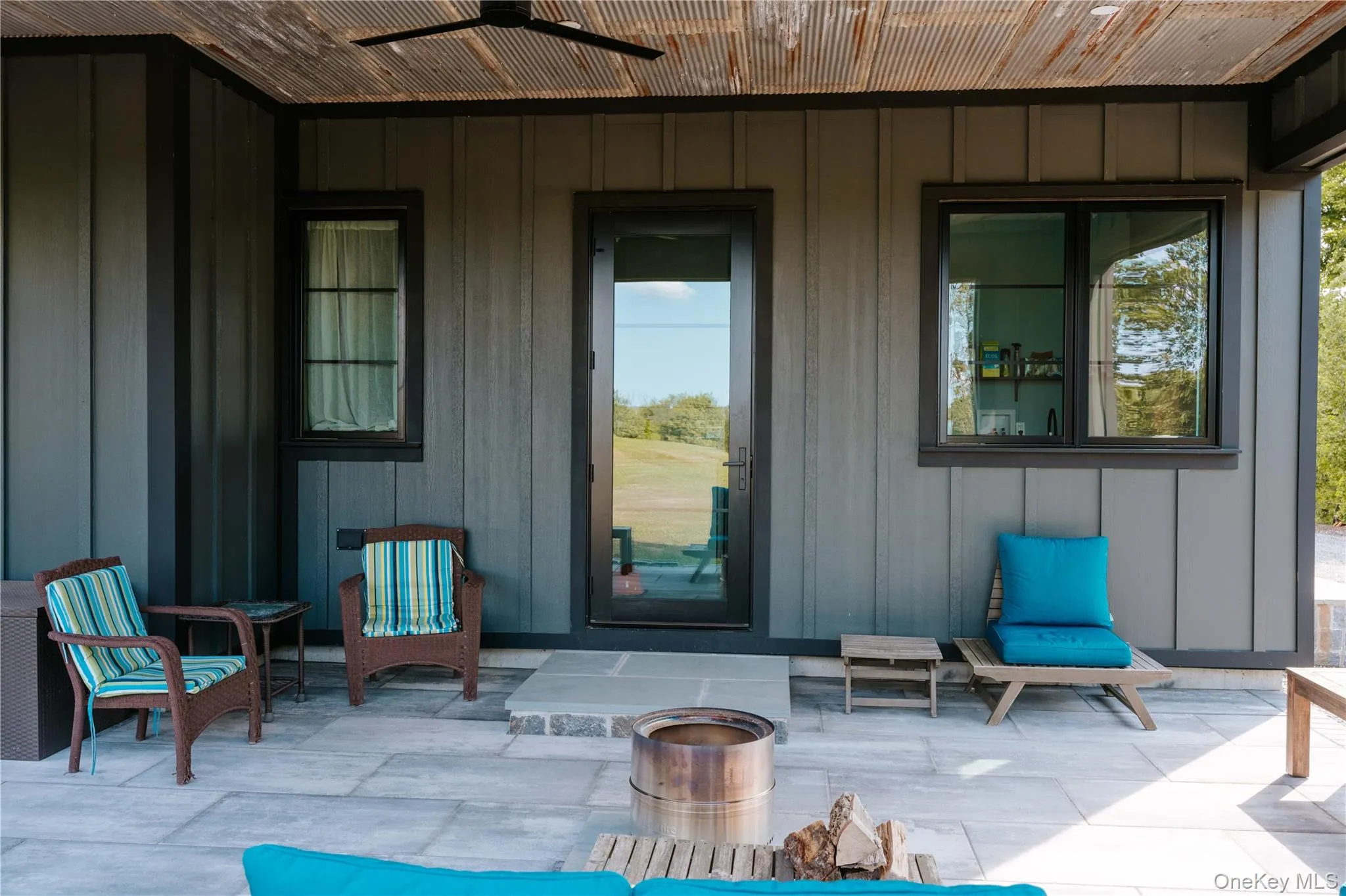 View of exterior entry featuring a patio, board and batten siding, and a ceiling fan View of exterior entry featuring a patio, board and batten siding, and a ceiling fan