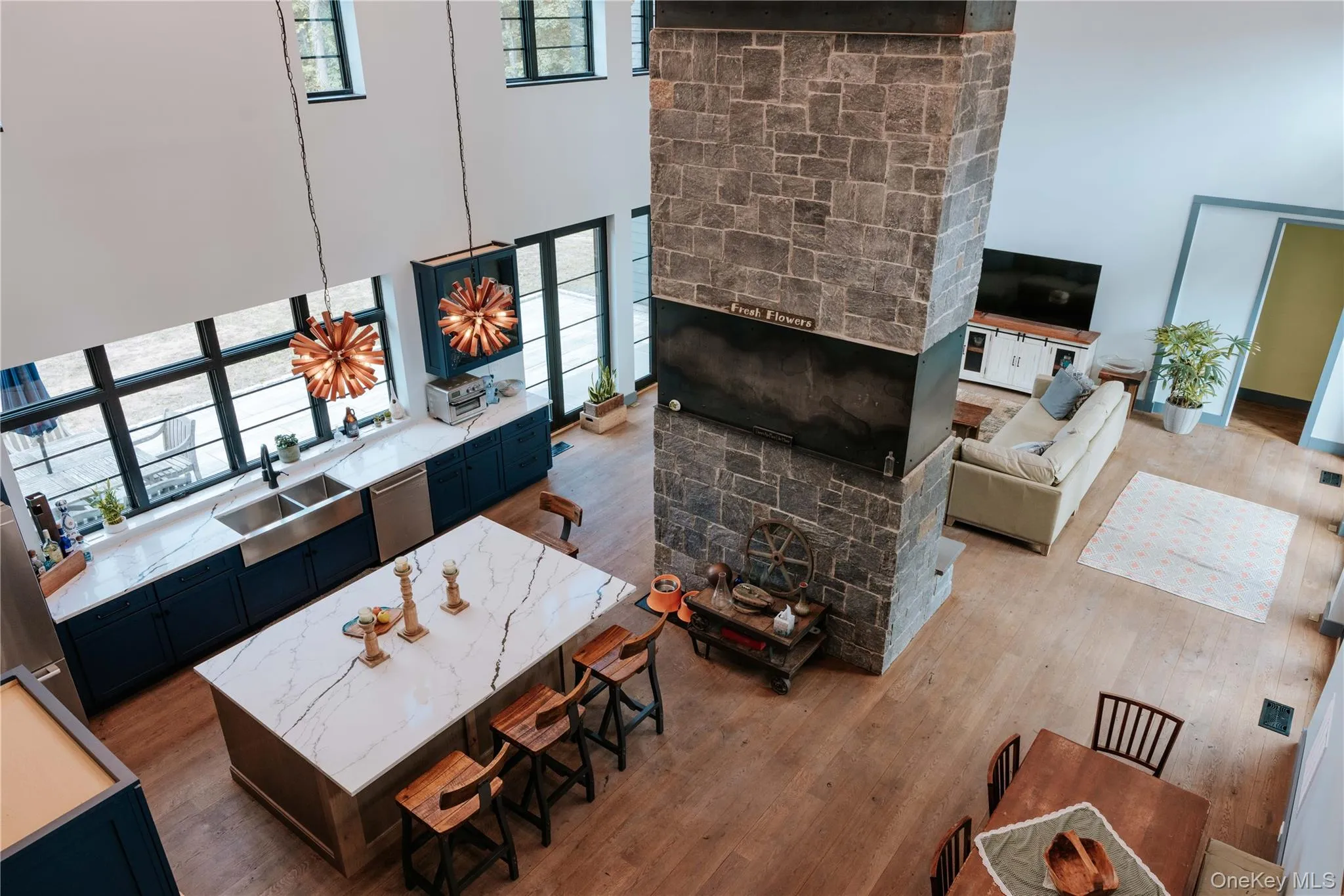 Living room with wood finished floors and a high ceiling Living room with wood finished floors and a high ceiling