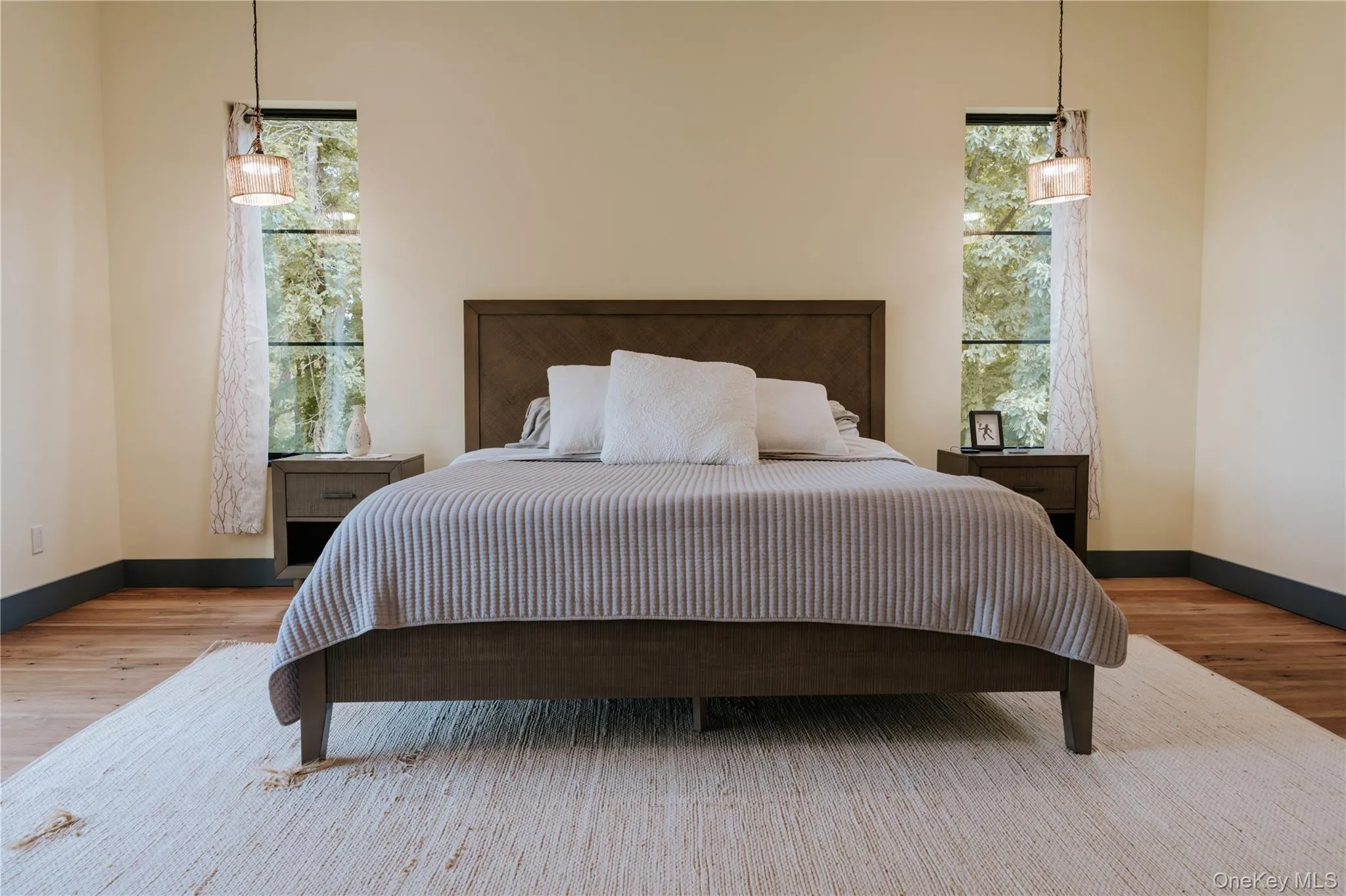 Bedroom featuring baseboards and wood finished floors Bedroom featuring baseboards and wood finished floors
