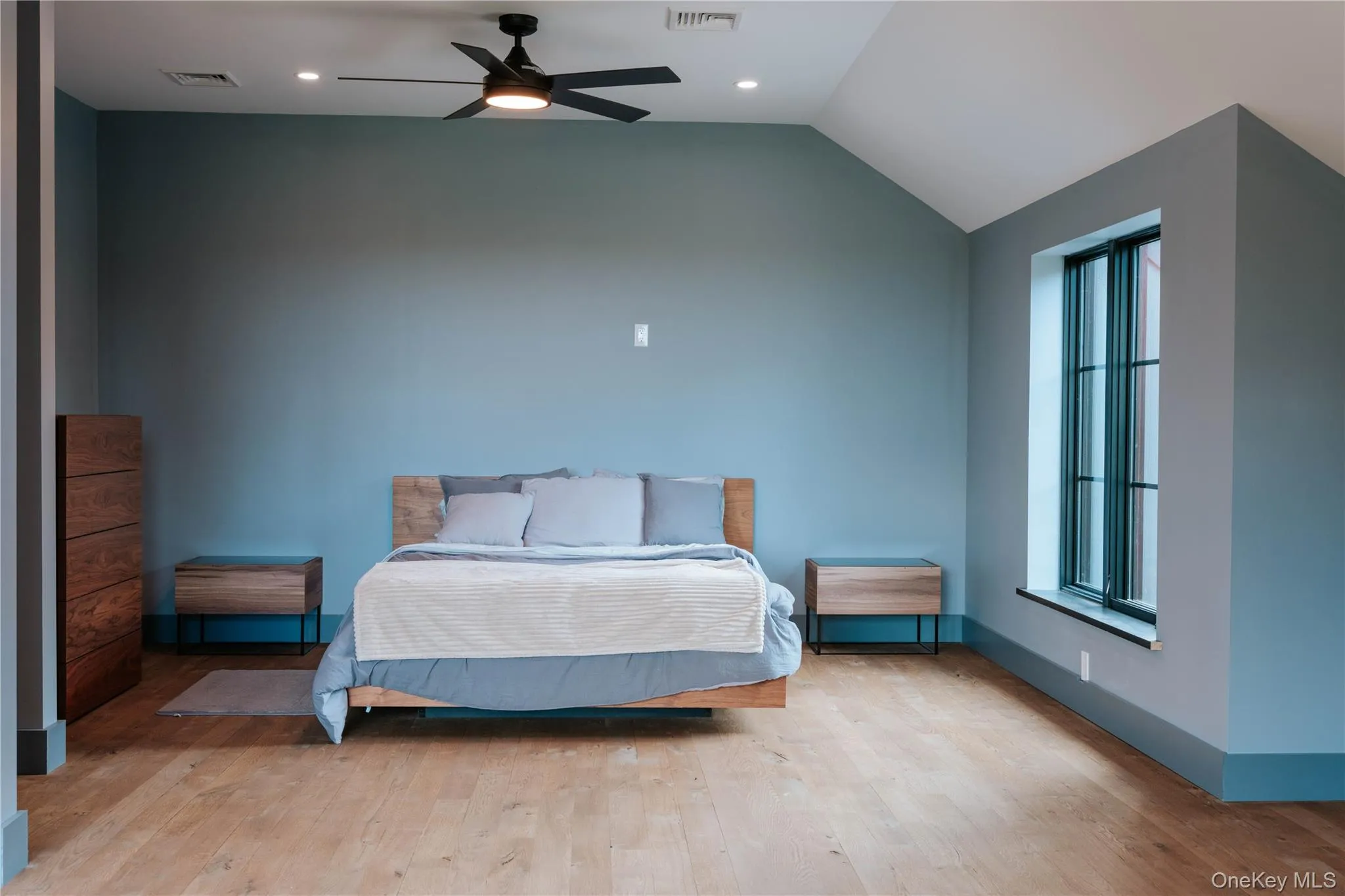 Bedroom with wood finished floors, lofted ceiling, ceiling fan, and recessed lighting Bedroom with wood finished floors, lofted ceiling, ceiling fan, and recessed lighting