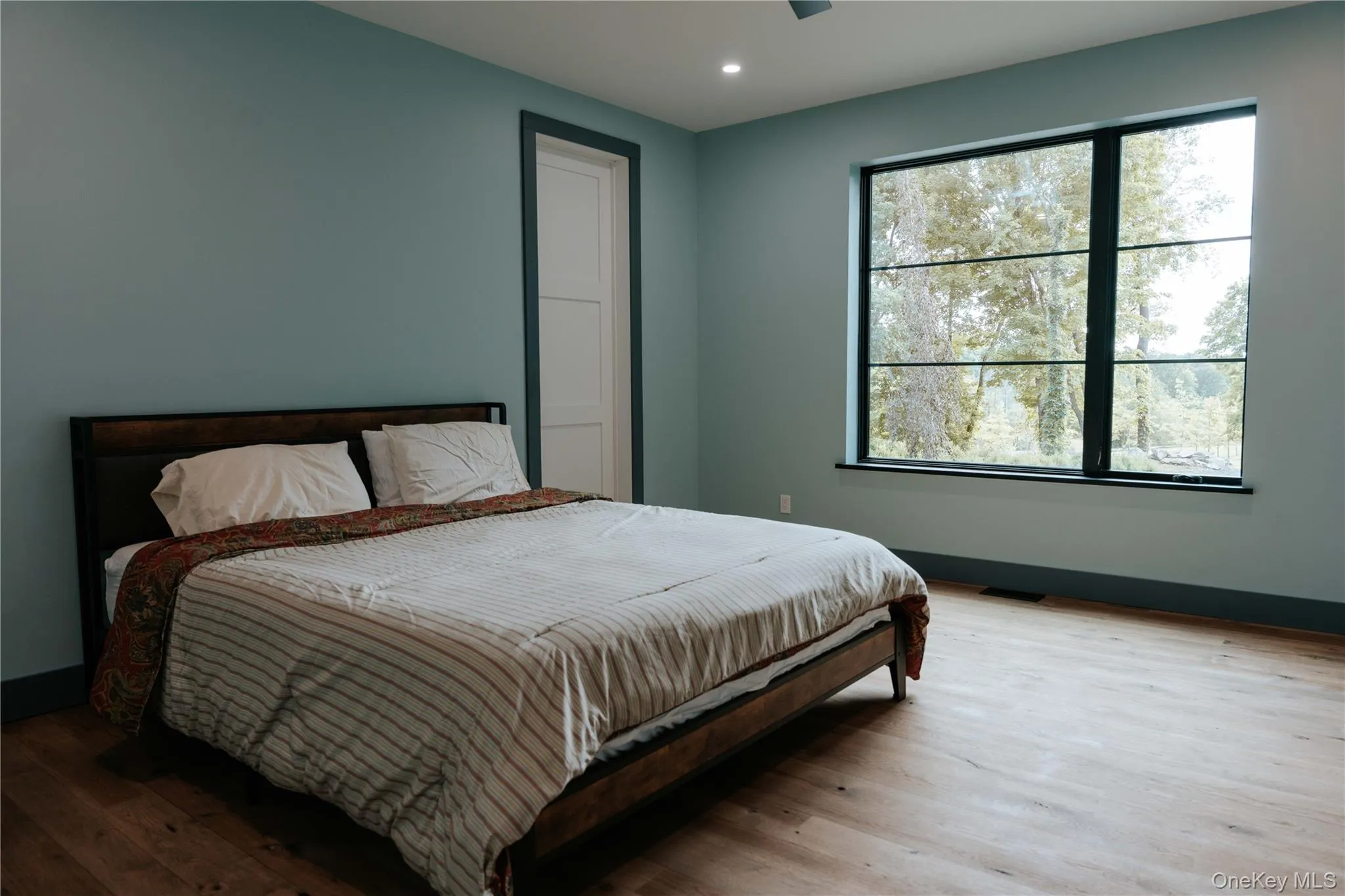 Bedroom with wood finished floors and recessed lighting Bedroom with wood finished floors and recessed lighting