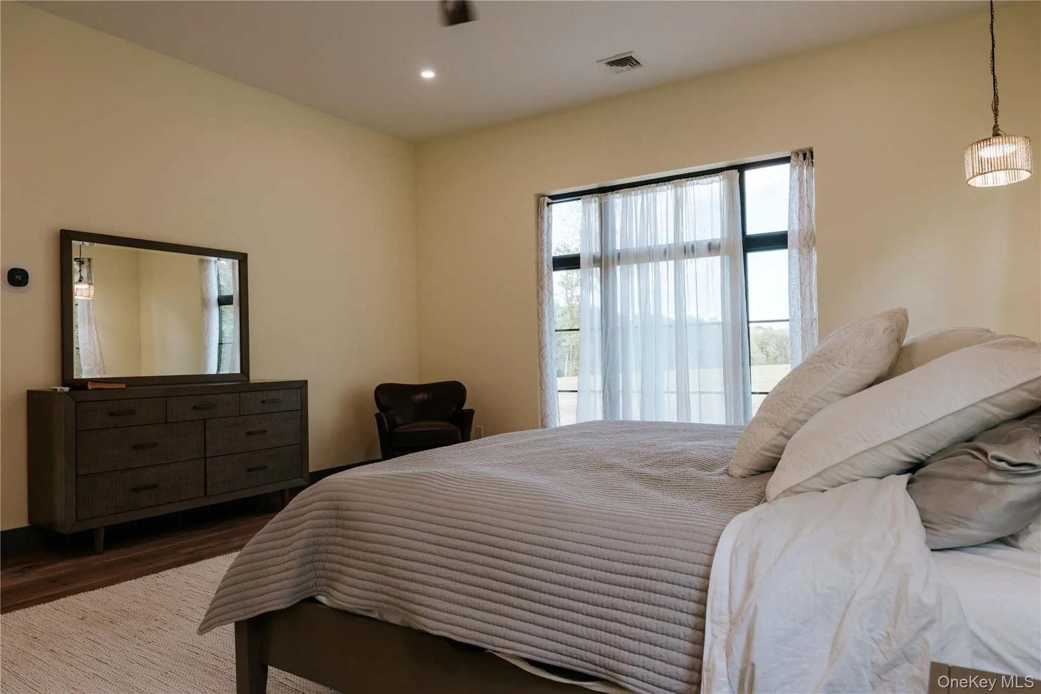 Bedroom featuring wood finished floors and recessed lighting Bedroom featuring wood finished floors and recessed lighting