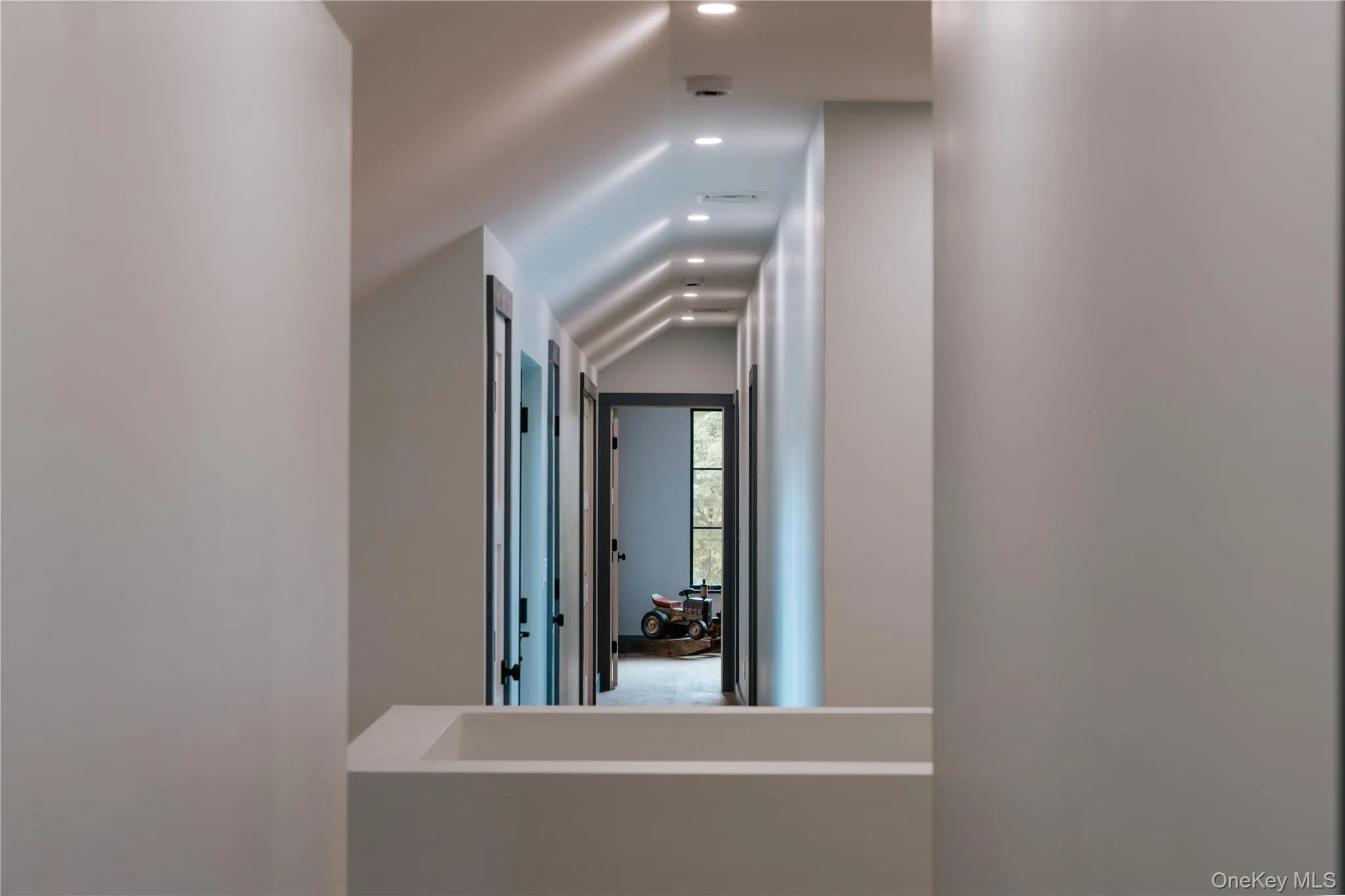 Hall featuring vaulted ceiling Hall featuring vaulted ceiling