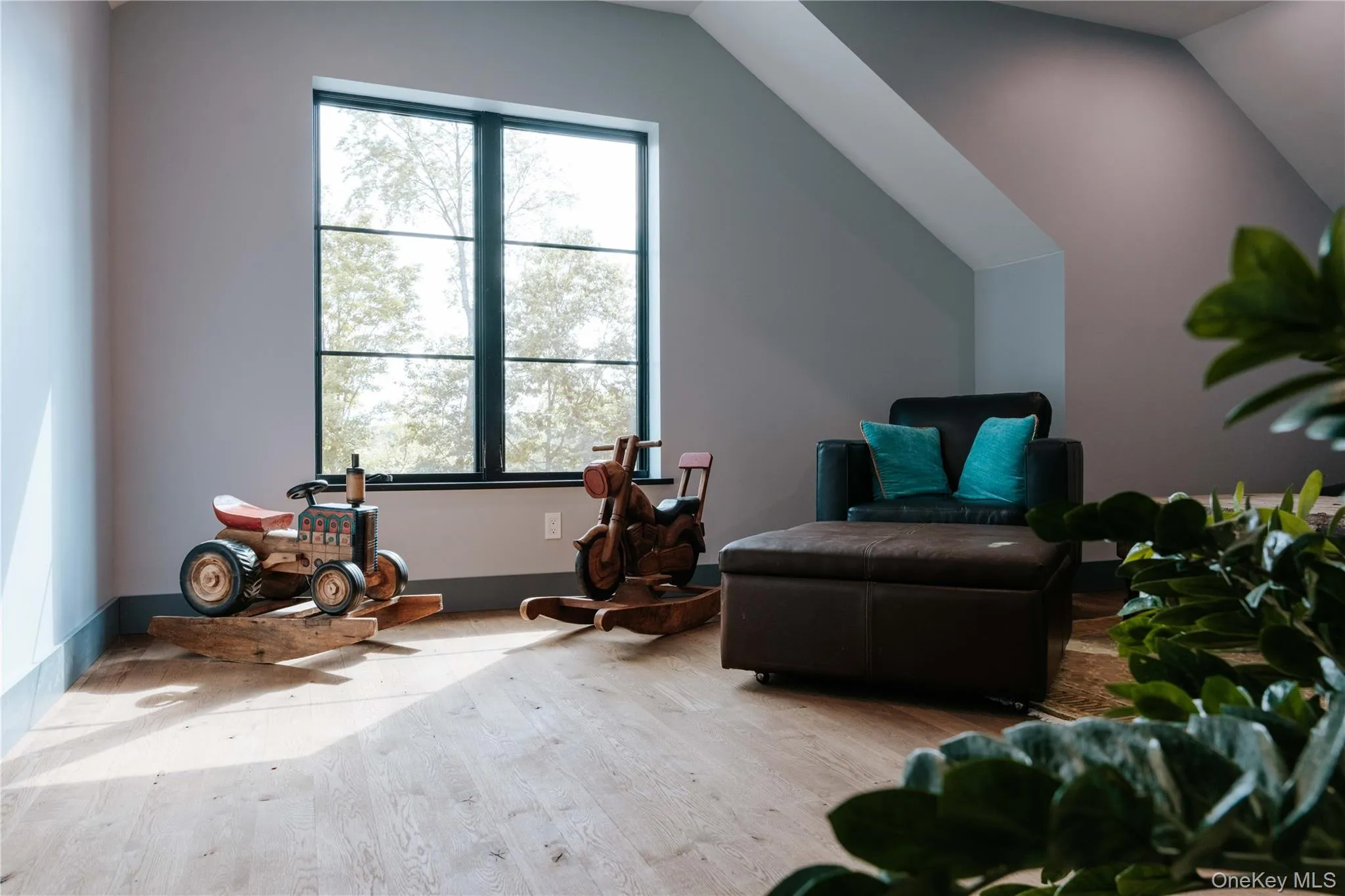 Sitting room with wood finished floors and lofted ceiling Sitting room with wood finished floors and lofted ceiling