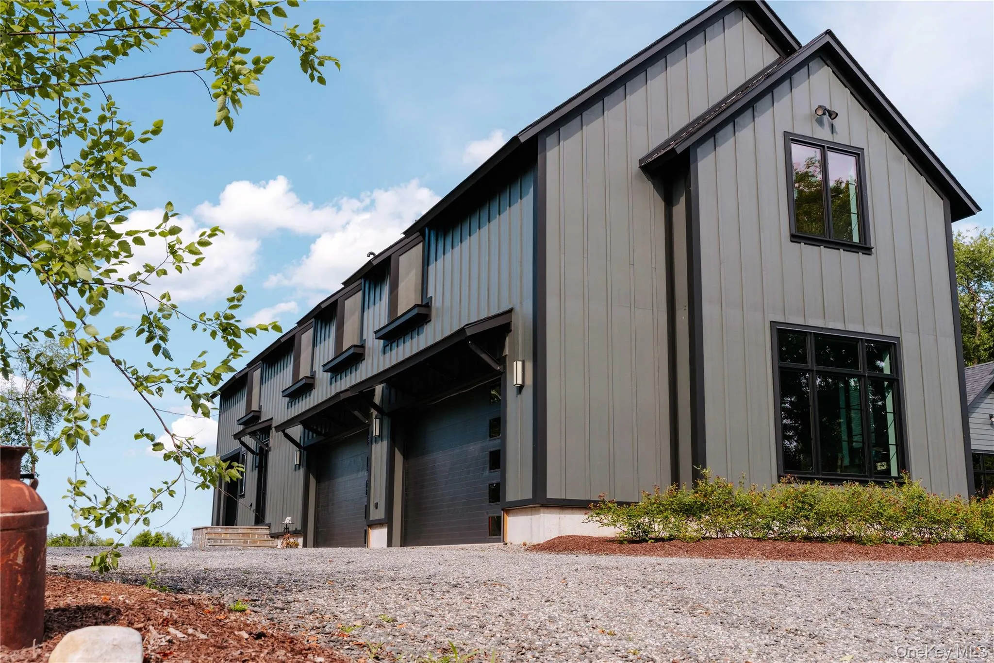 Modern farmhouse style home featuring board and batten siding and a garage Modern farmhouse style home featuring board and batten siding and a garage