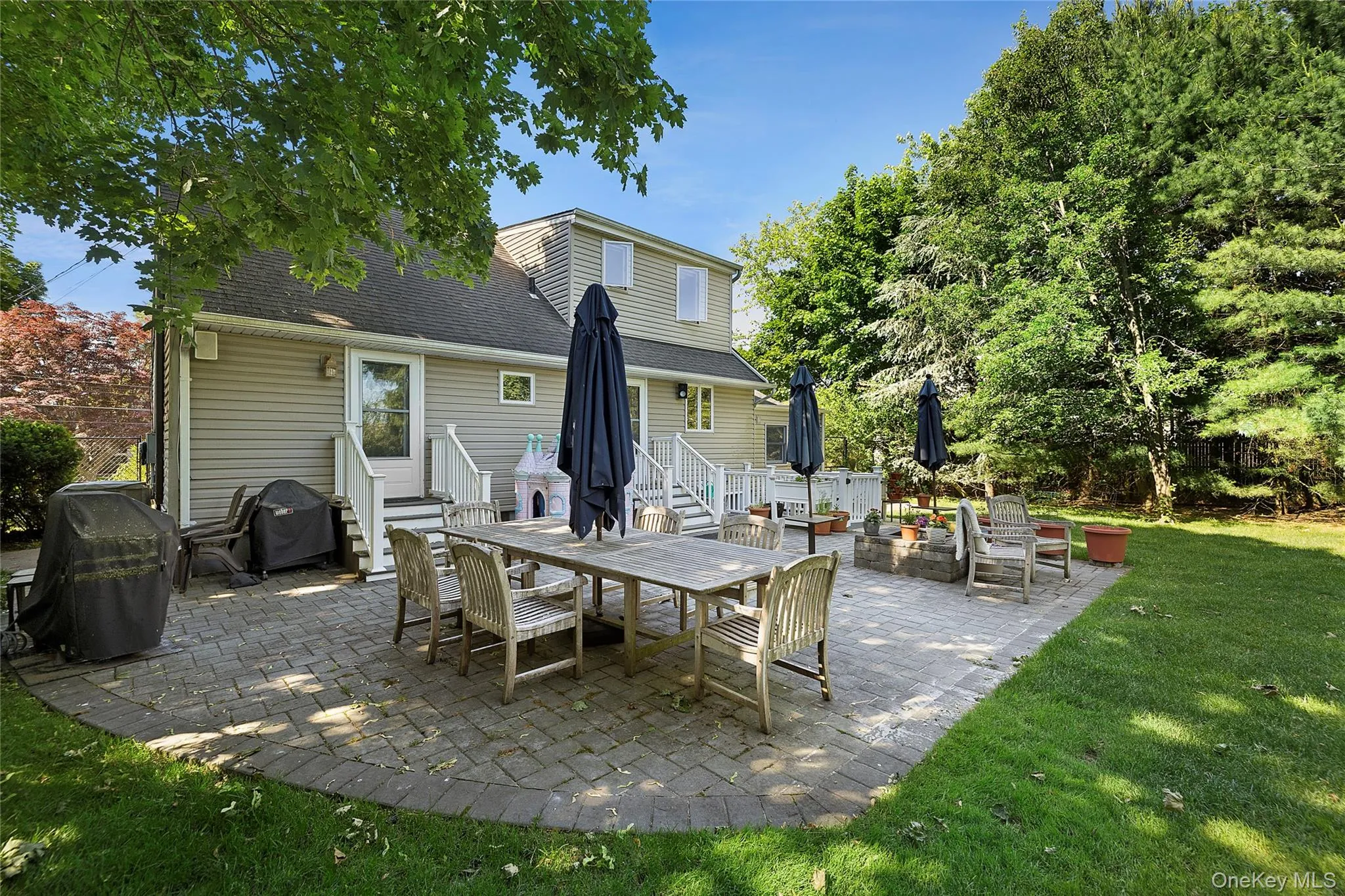 Large outdoor patio with ample seating and built-in fire pit Large outdoor patio with ample seating and built-in fire pit
