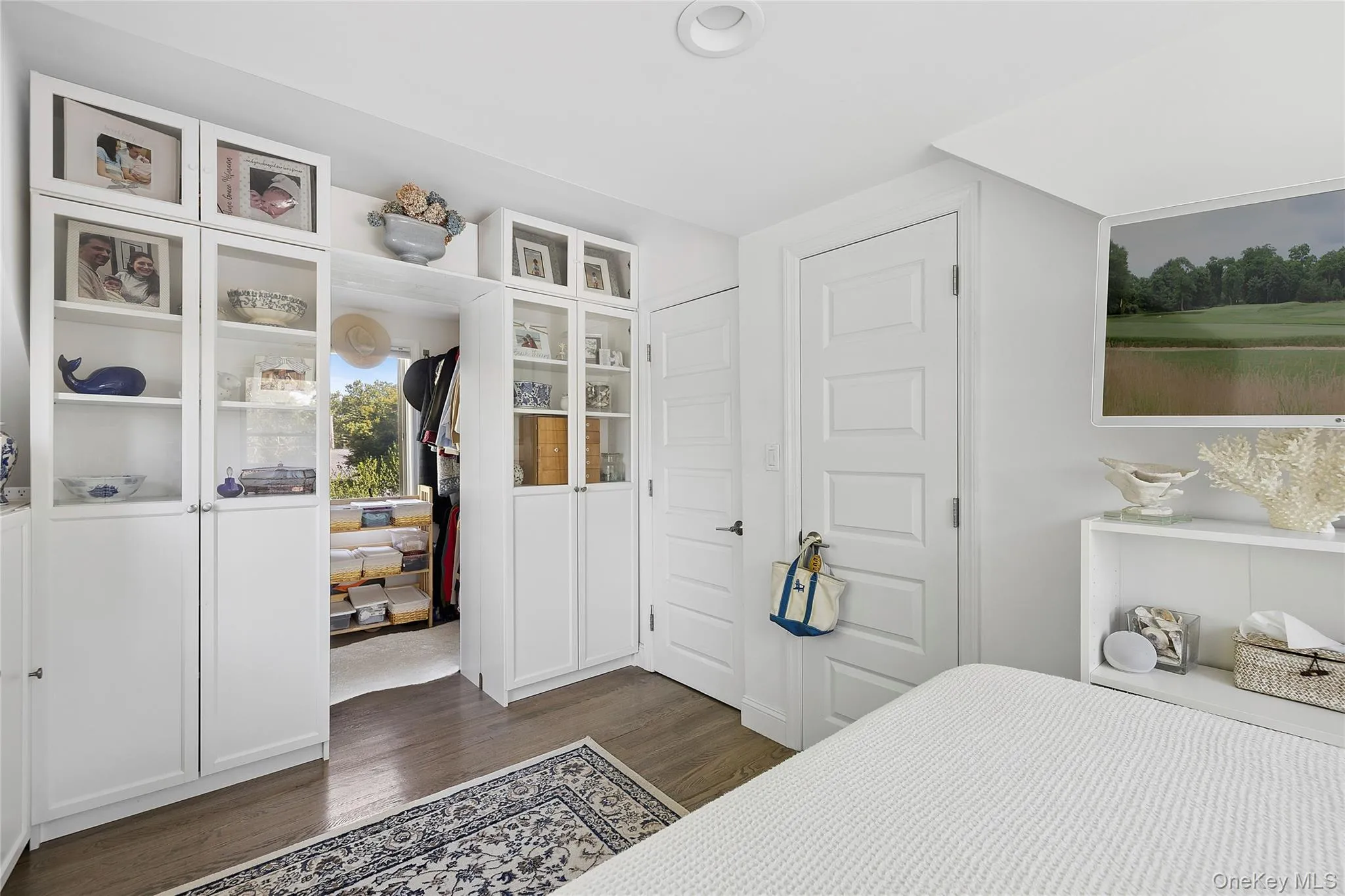 Custom built-in cabinetry featuring glass-front doors Custom built-in cabinetry featuring glass-front doors