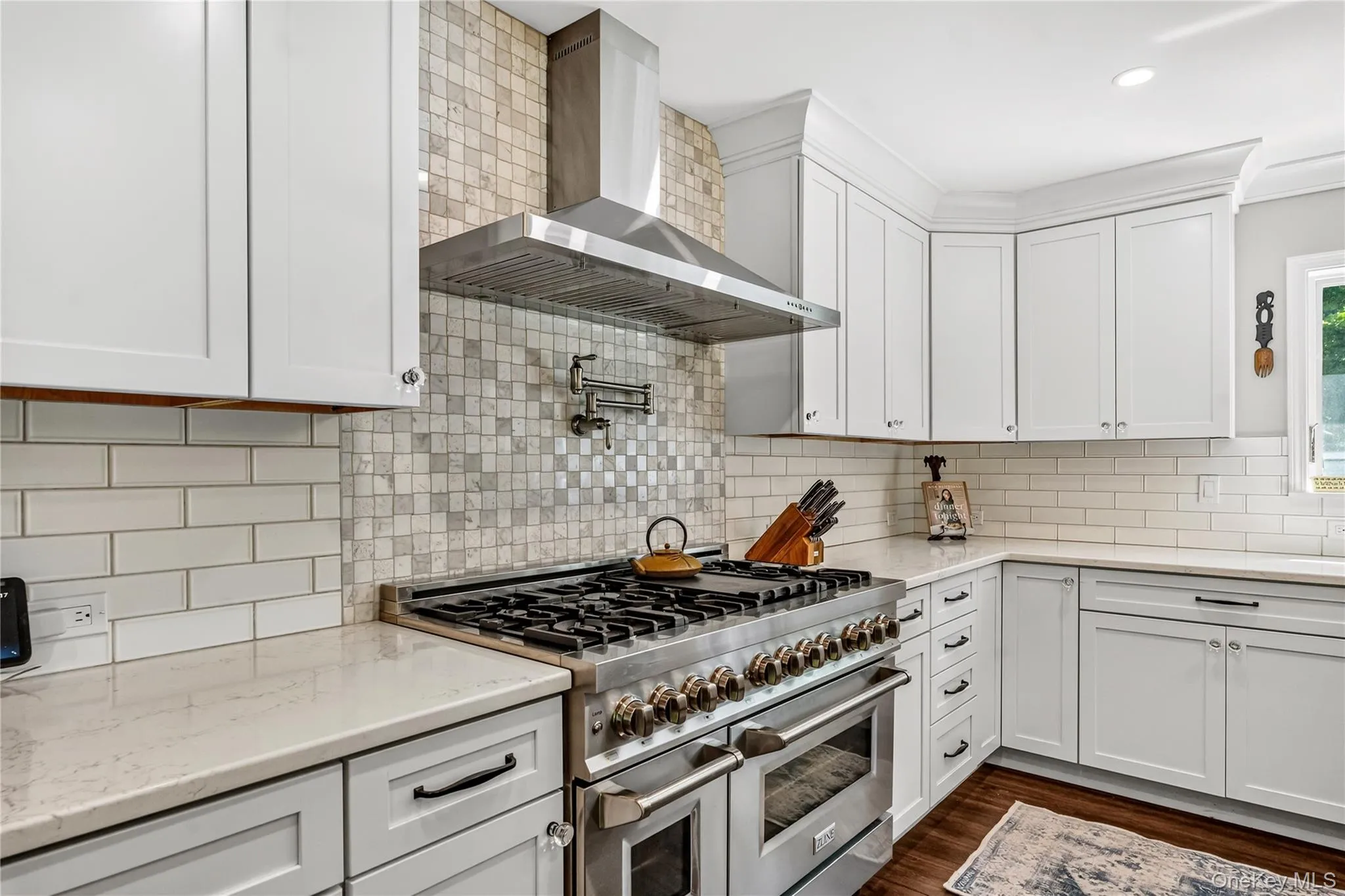 Gourmet kitchen featuring a professional-grade stainless steel range with double ovens, a coordinating stainless steel range hood, Gourmet kitchen featuring a professional-grade stainless steel range with double ovens, a coordinating stainless steel range hood,