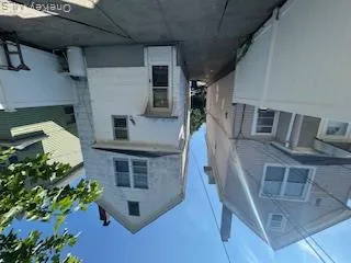 Rear view of house with a chimney, a patio, and a fenced backyard Rear view of house with a chimney, a patio, and a fenced backyard