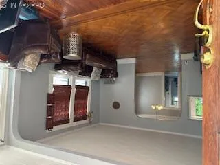 Living room with arched walkways, healthy amount of natural light, and ornamental molding Living room with arched walkways, healthy amount of natural light, and ornamental molding