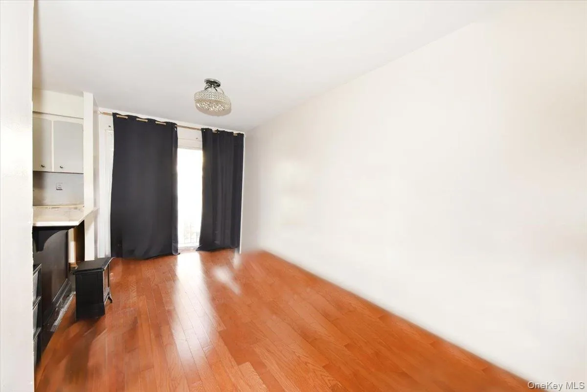 Unfurnished living room featuring light wood-style flooring Unfurnished living room featuring light wood-style flooring