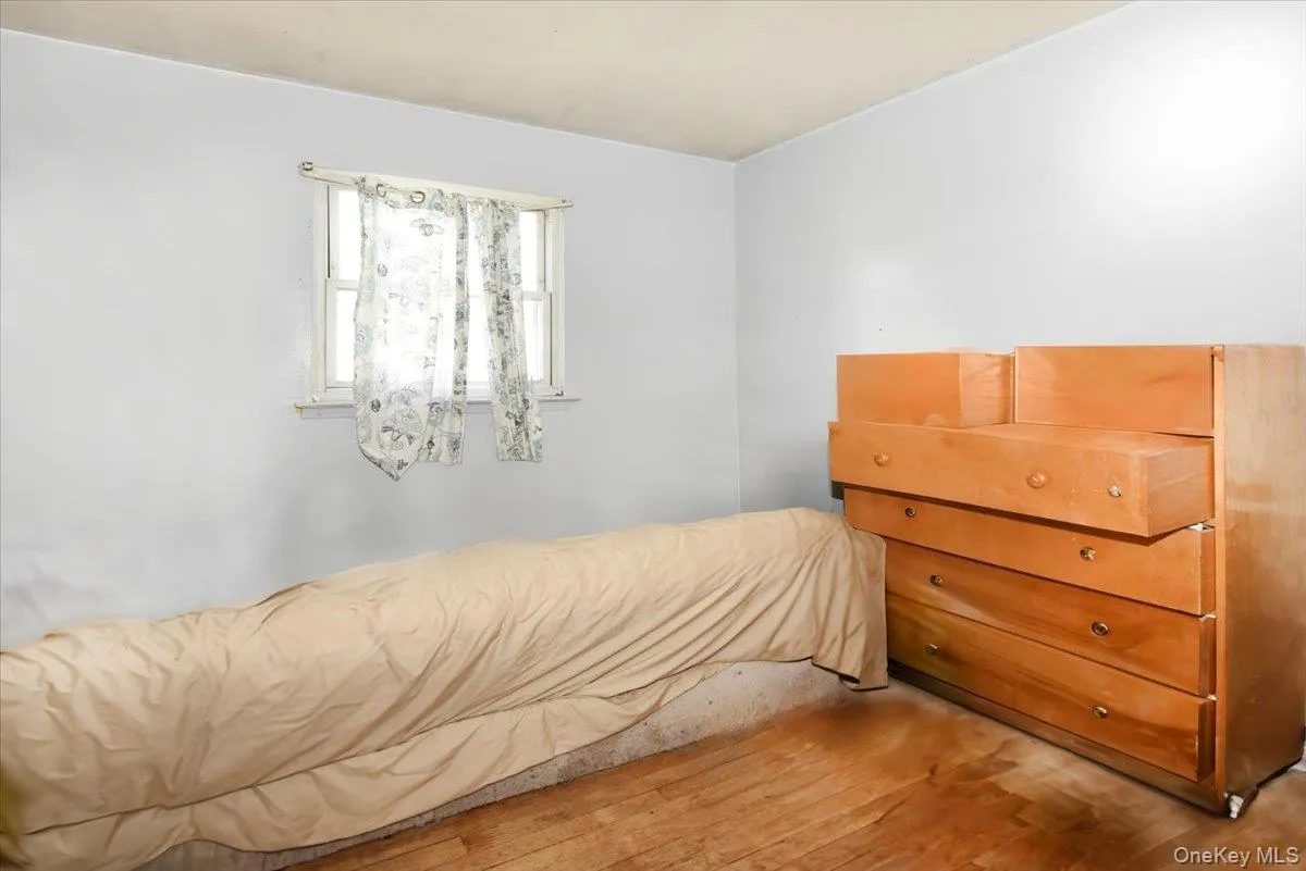 Bedroom featuring wood finished floors Bedroom featuring wood finished floors
