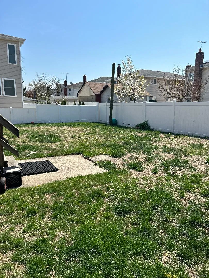 View of yard featuring fence View of yard featuring fence