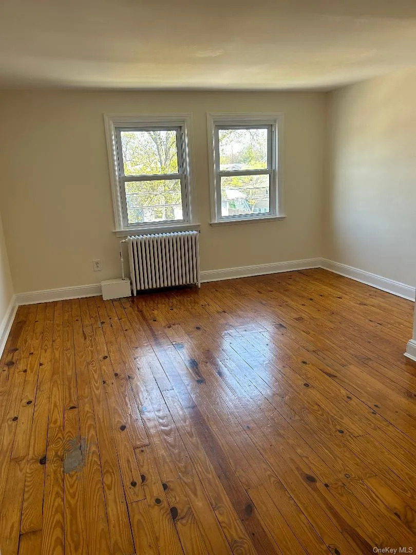 Wood-type flooring, radiator heating unit, and baseboards Wood-type flooring, radiator heating unit, and baseboards