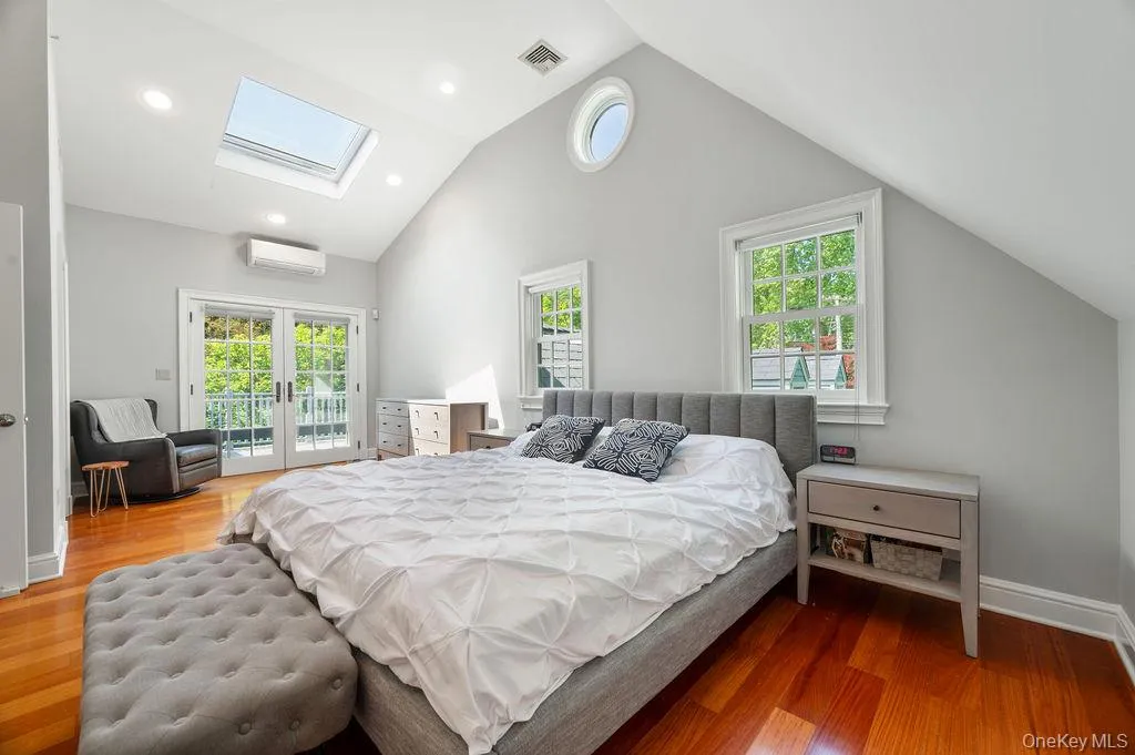 Primary bedroom suite with French doors to balcony overlooking beautiful yard replete with specimen plantings. Primary bedroom suite with French doors to balcony overlooking beautiful yard replete with specimen plantings.