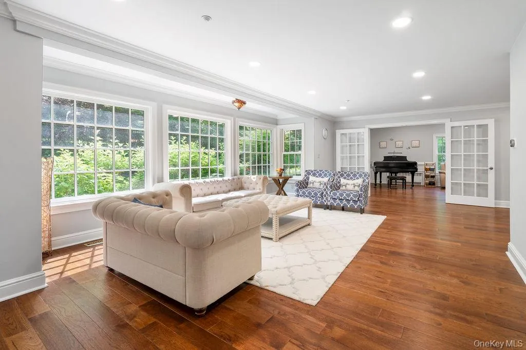 Sun filled formal Living Room with oversized windows. Sun filled formal Living Room with oversized windows.