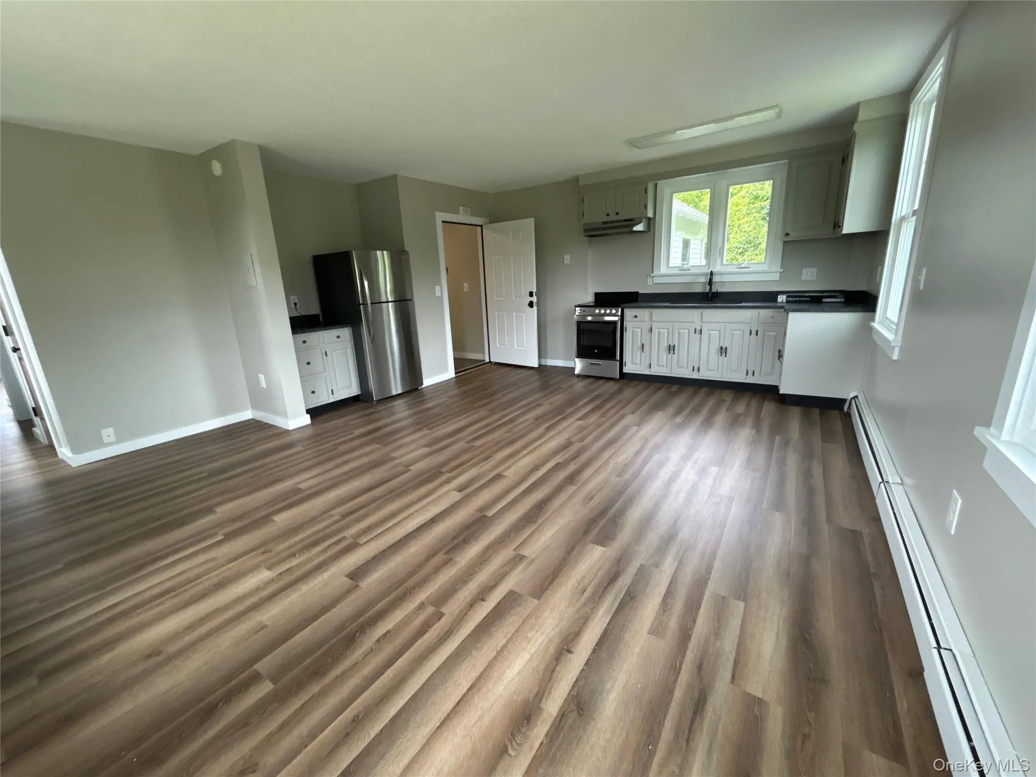Second floor #4 - two bedroom apartment open concept view from living room, dining room into kitchen Second floor #4 - two bedroom apartment open concept view from living room, dining room into kitchen