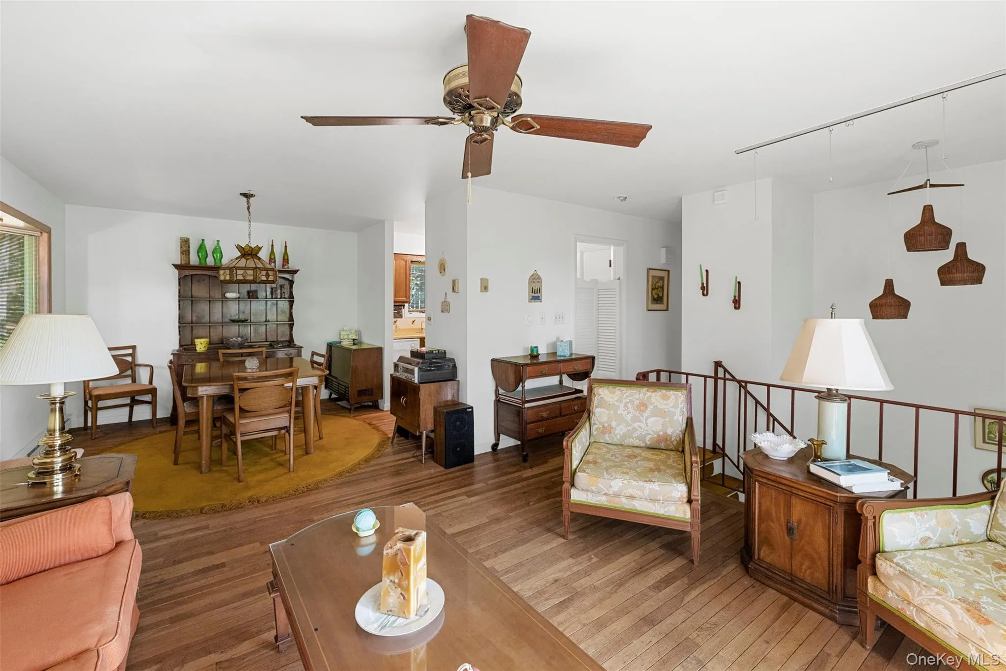 Living room with wood-type flooring and ceiling fan Living room with wood-type flooring and ceiling fan