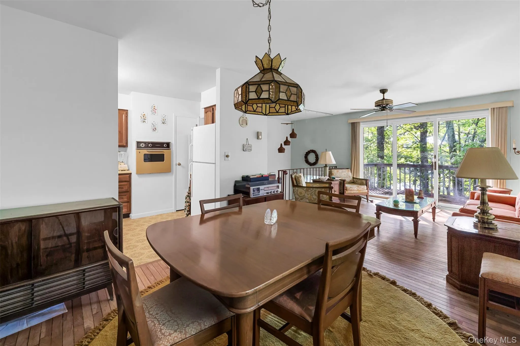 Dining space featuring light wood-style floors and a ceiling fan Dining space featuring light wood-style floors and a ceiling fan