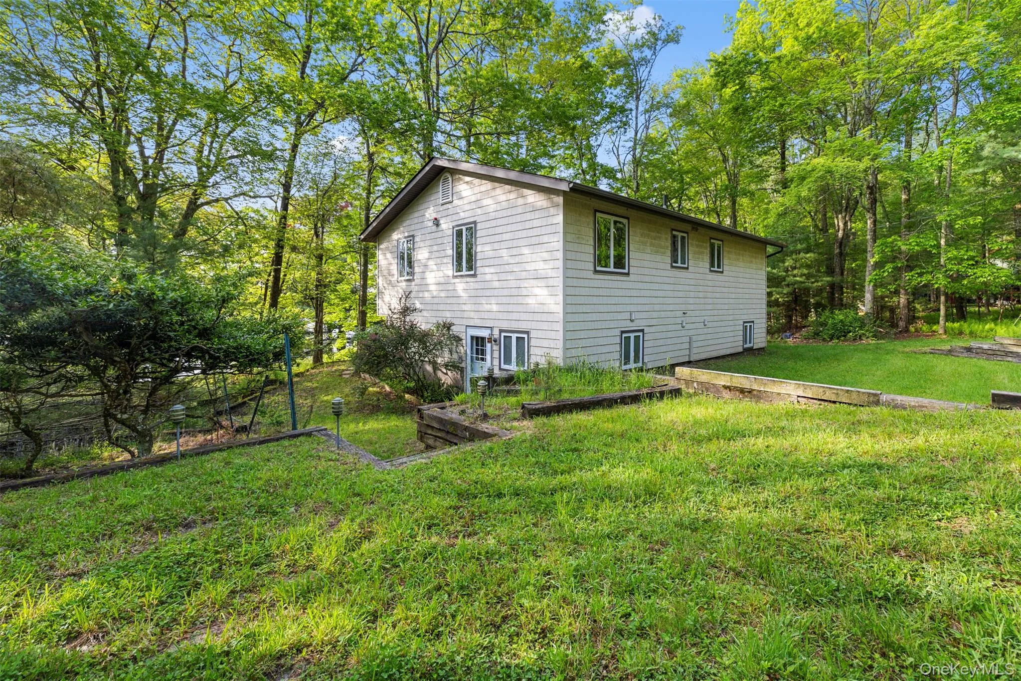 View of property exterior featuring a yard View of property exterior featuring a yard