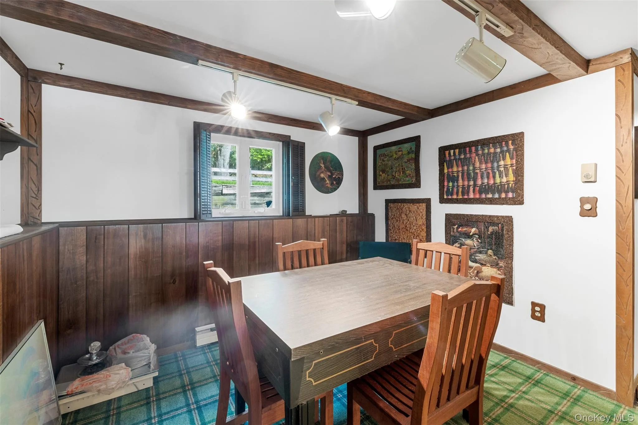 Dining room featuring beamed ceiling and baseboards Dining room featuring beamed ceiling and baseboards