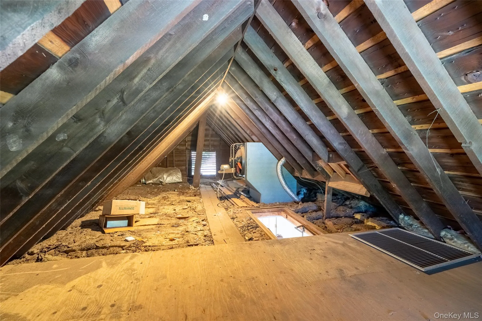 Exposed wooden rafters and ceiling joists in the attic space Exposed wooden rafters and ceiling joists in the attic space